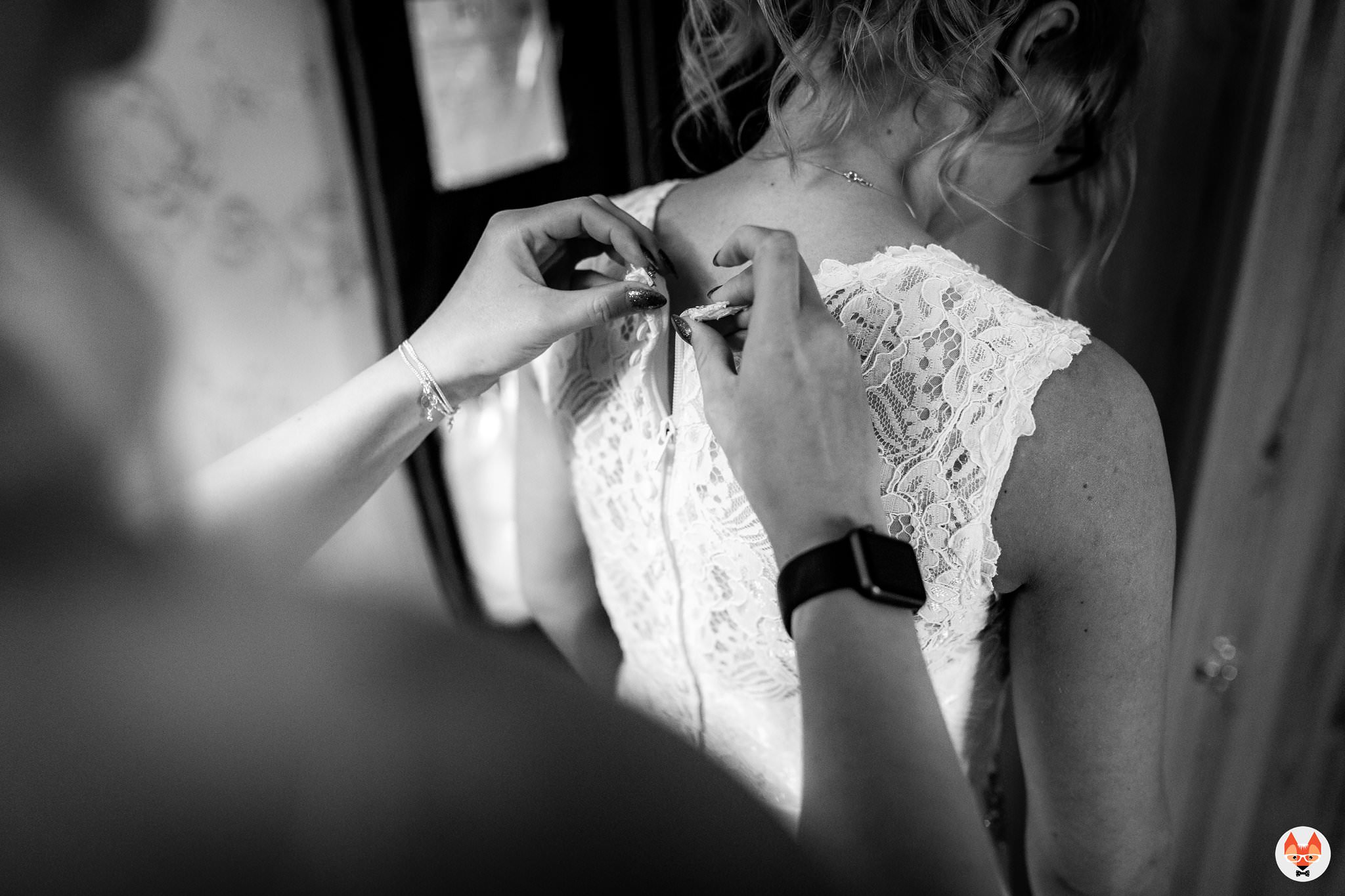 buttoning up the wedding dress
