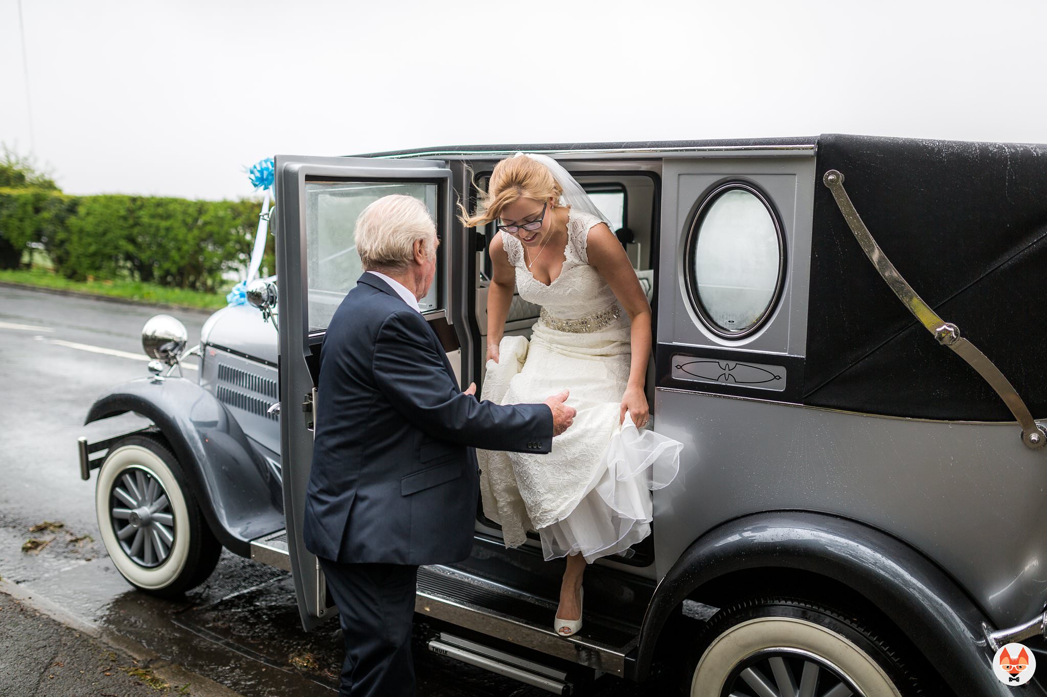 bride stepping out of the wedding car