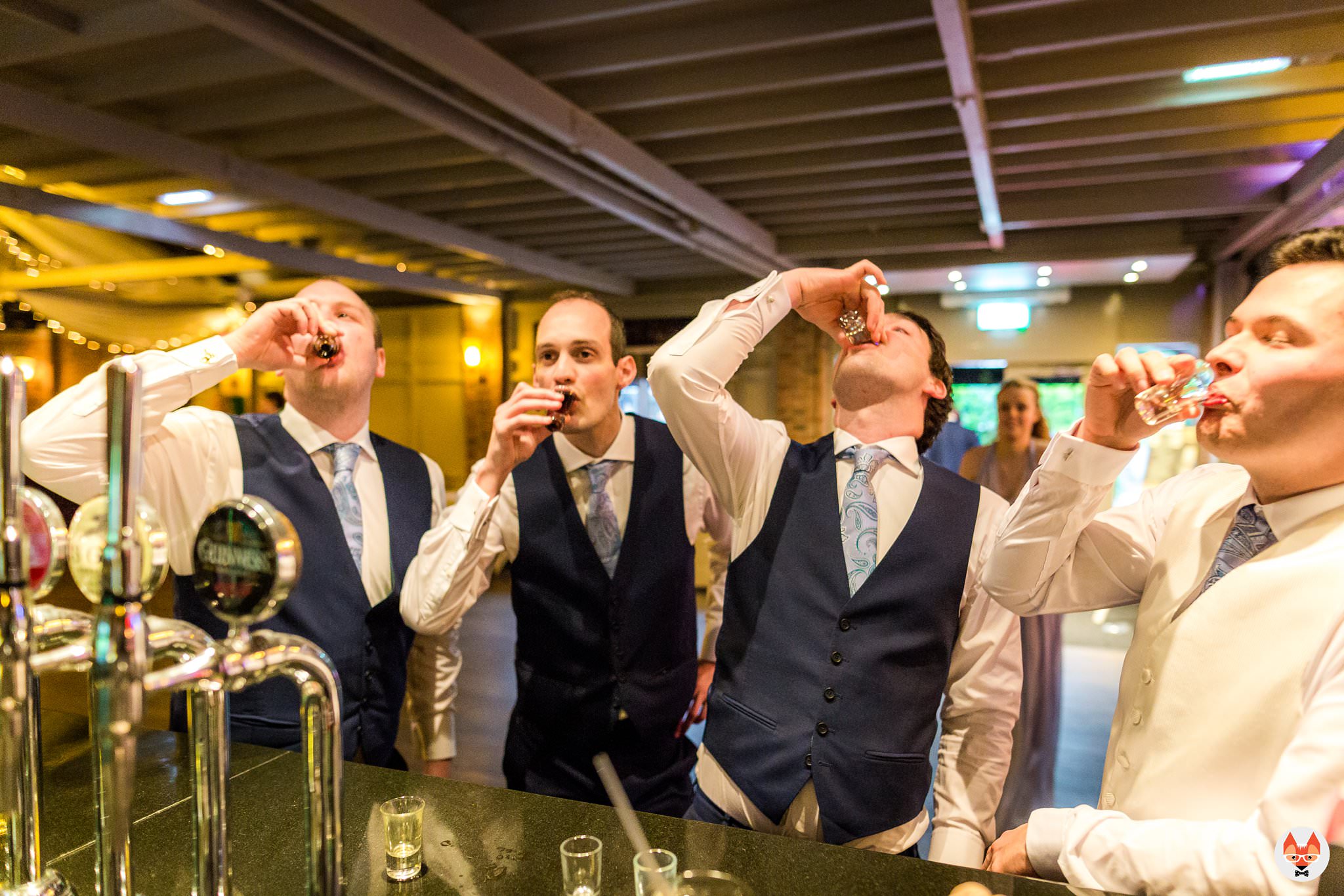 groomsmen doing shots at bar