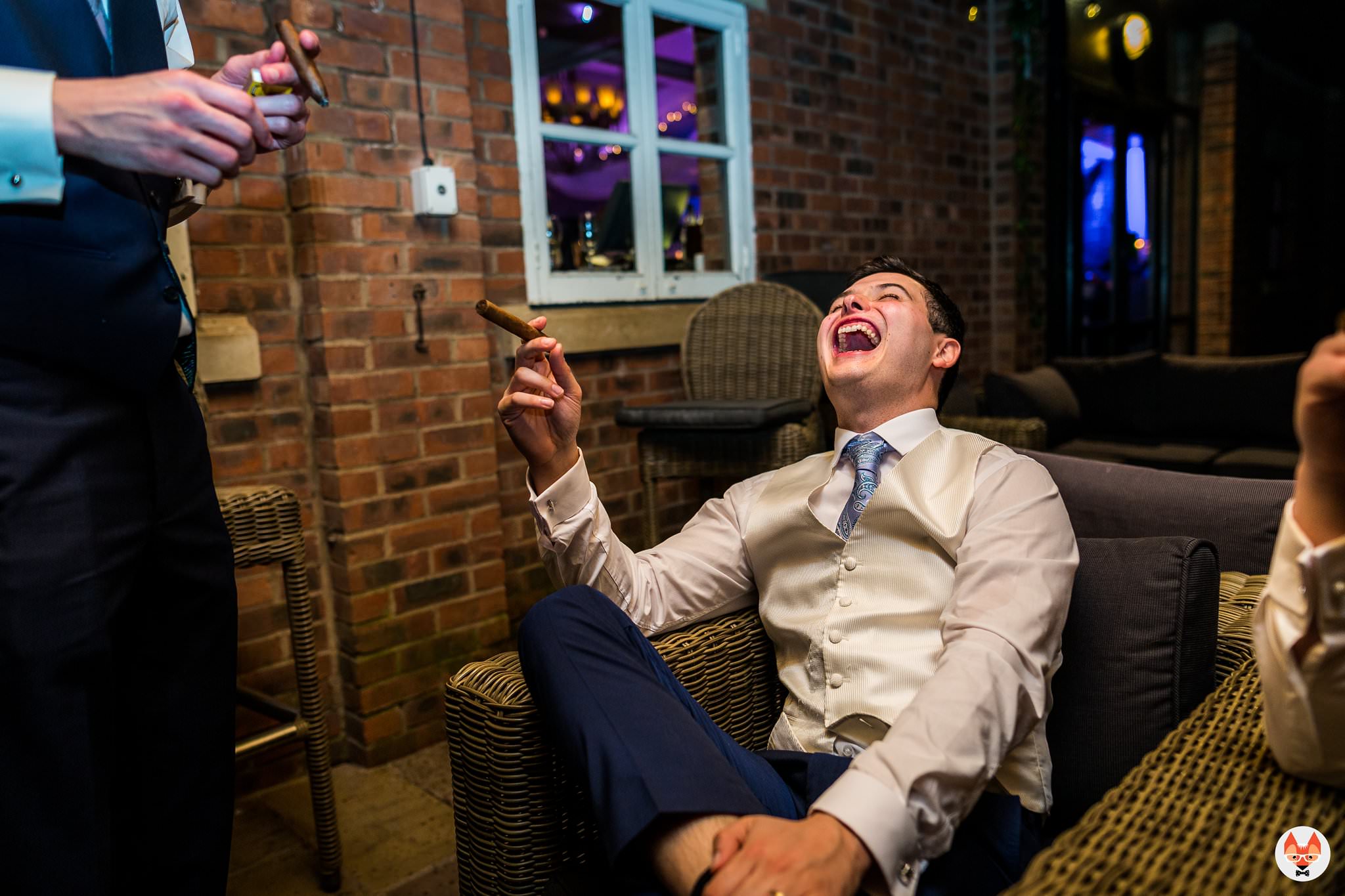 groomsmen laughing with cigars