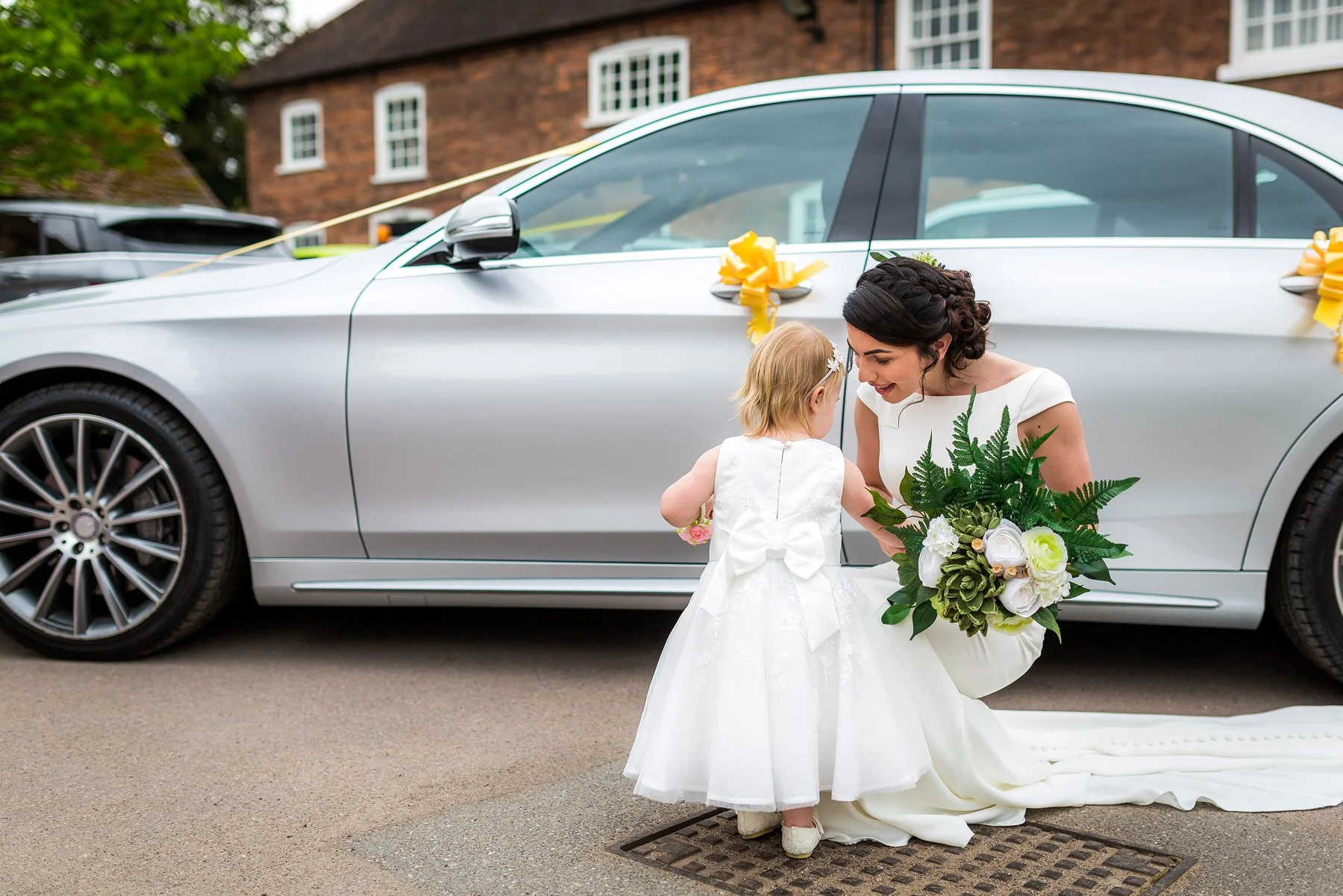 bride greeted by flower girl