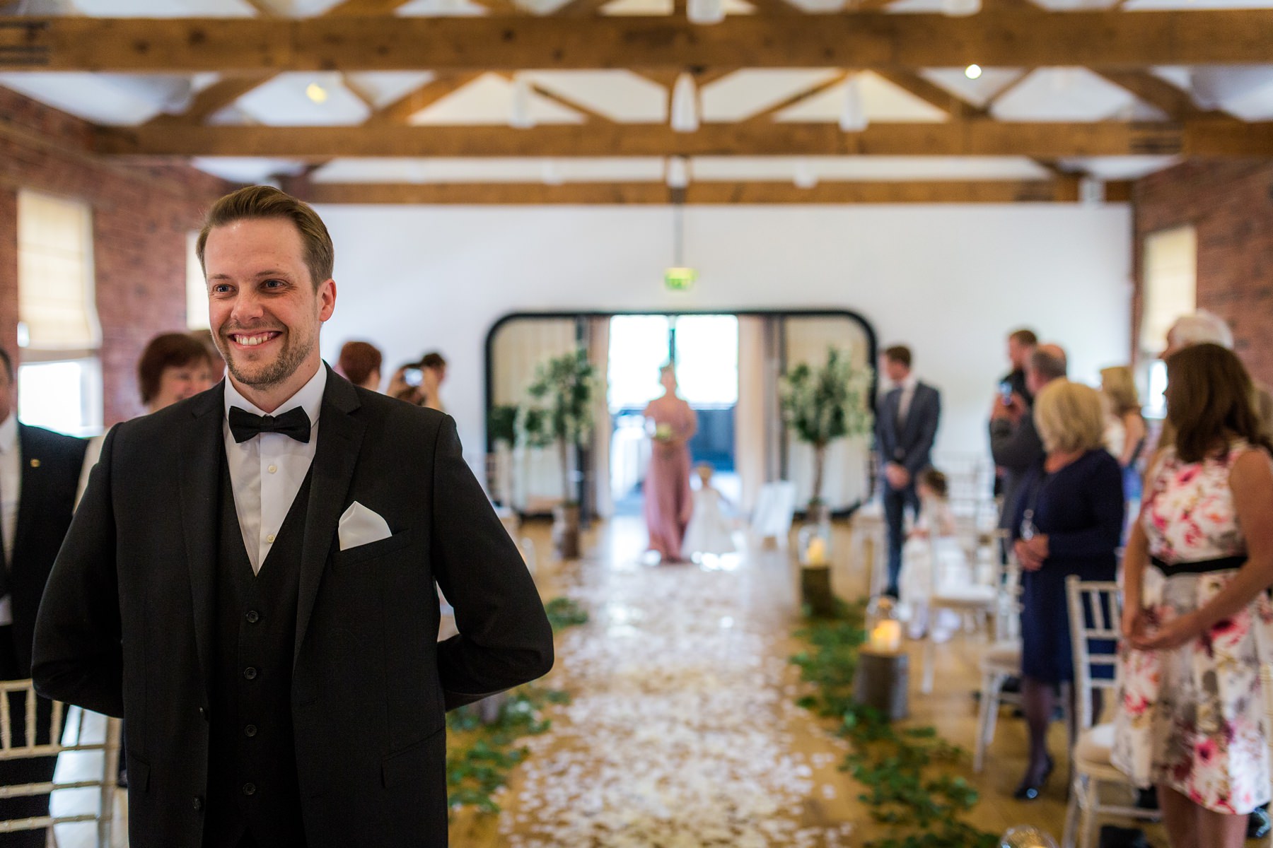 Groom smiling as music starts