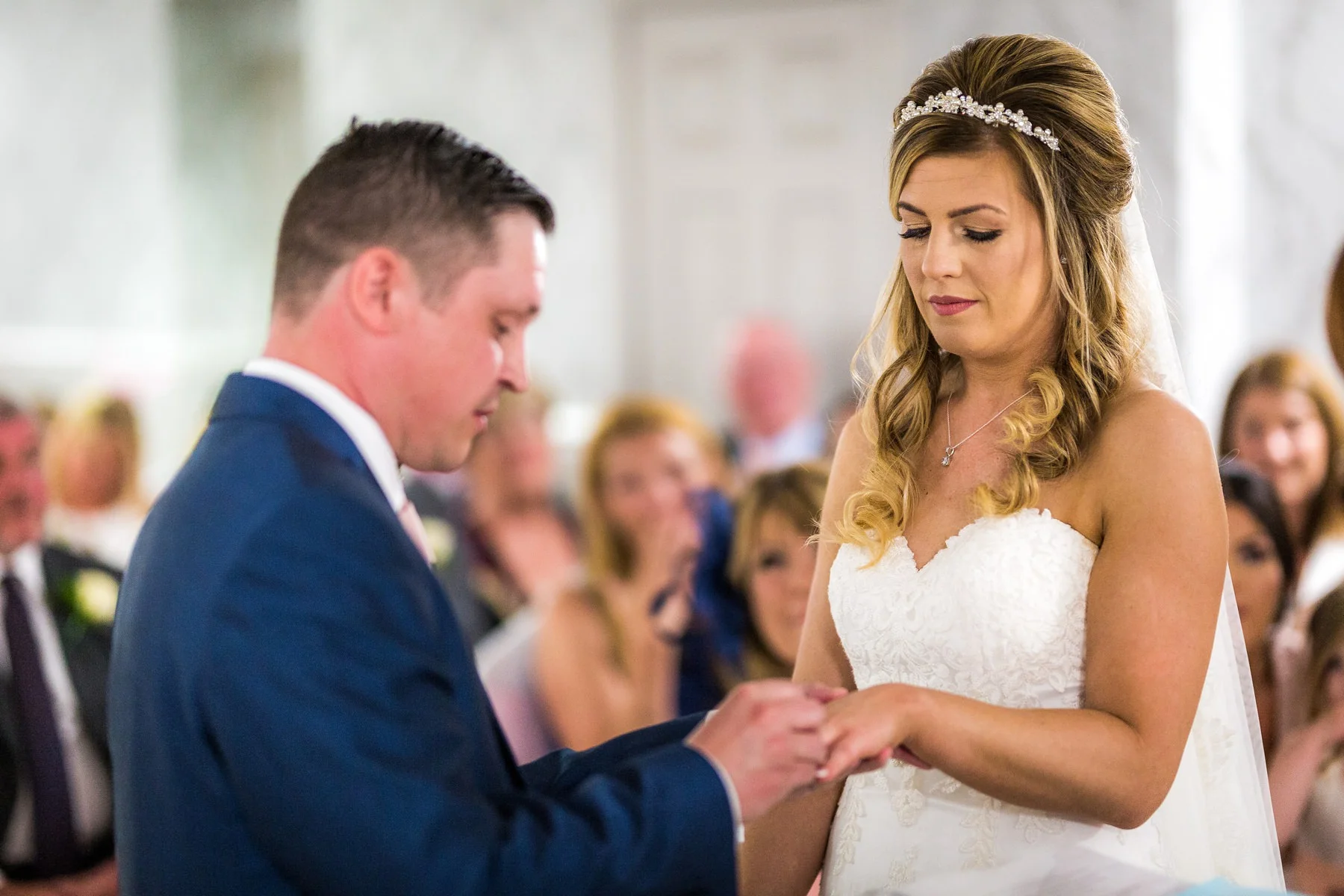 bride and groom exchanging wedding rings