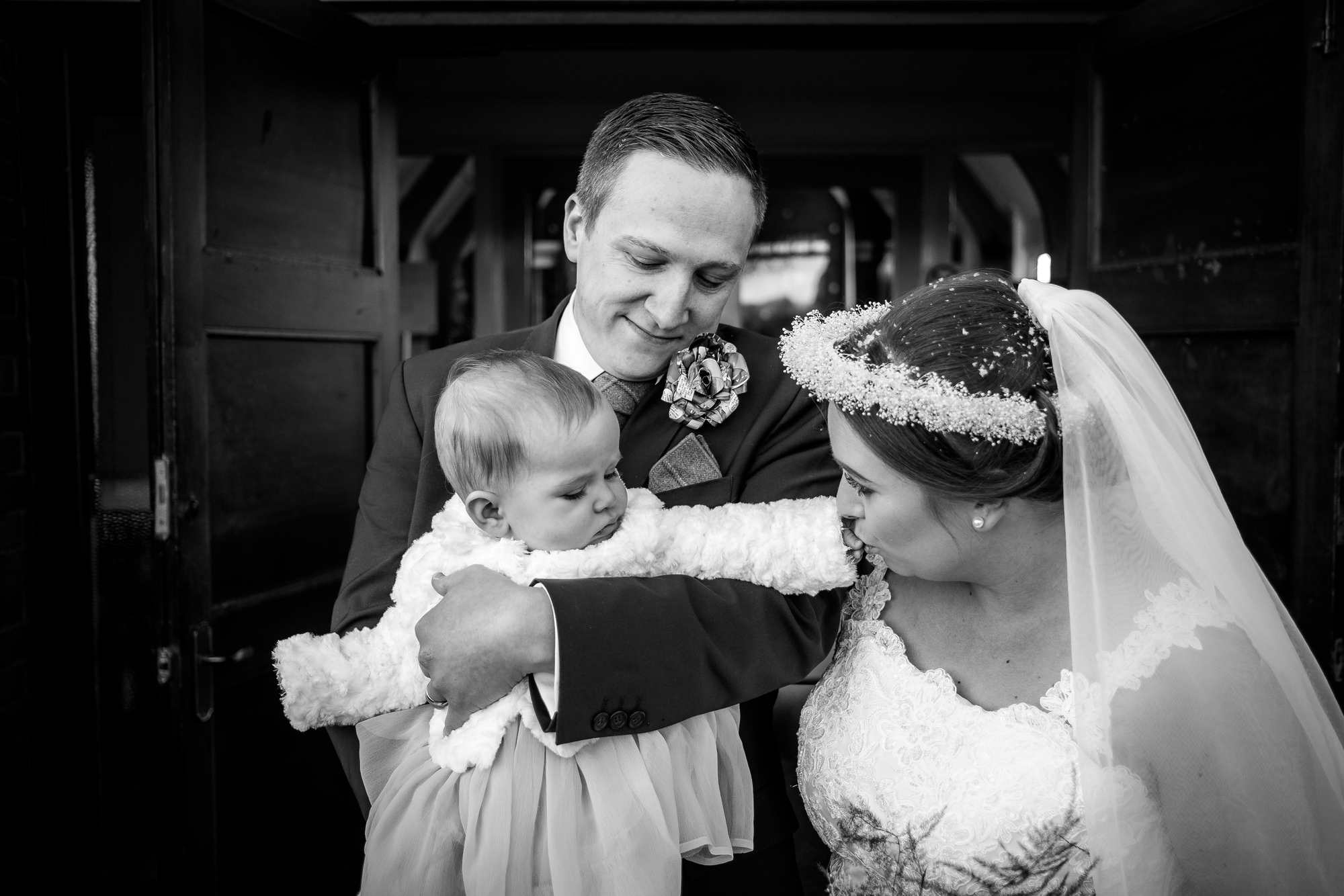 bride and groom with their daughter