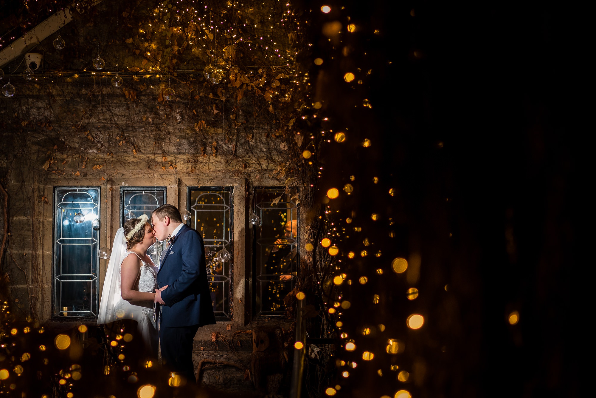 couples portrait with fairy lights