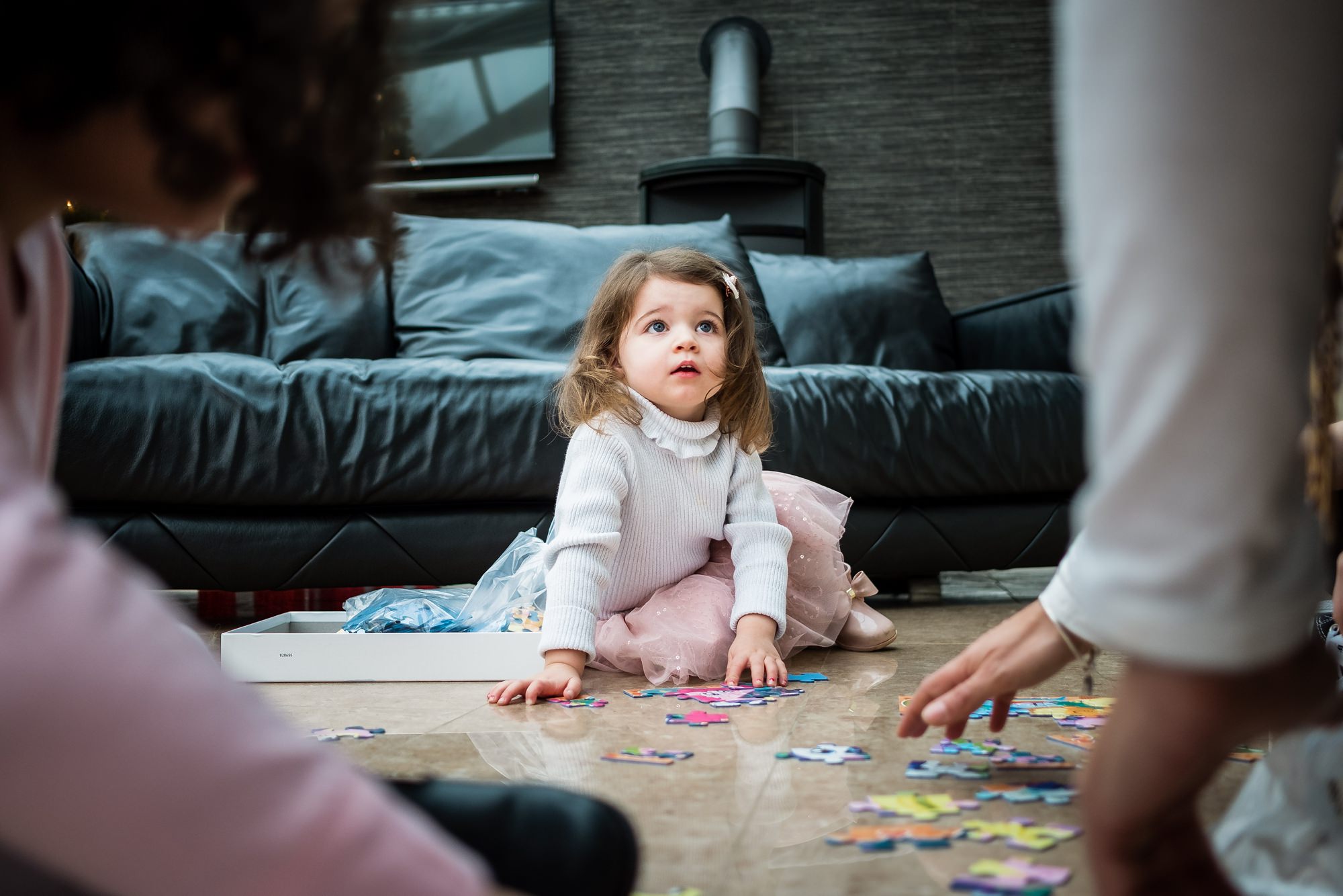 little girl on floor with toys