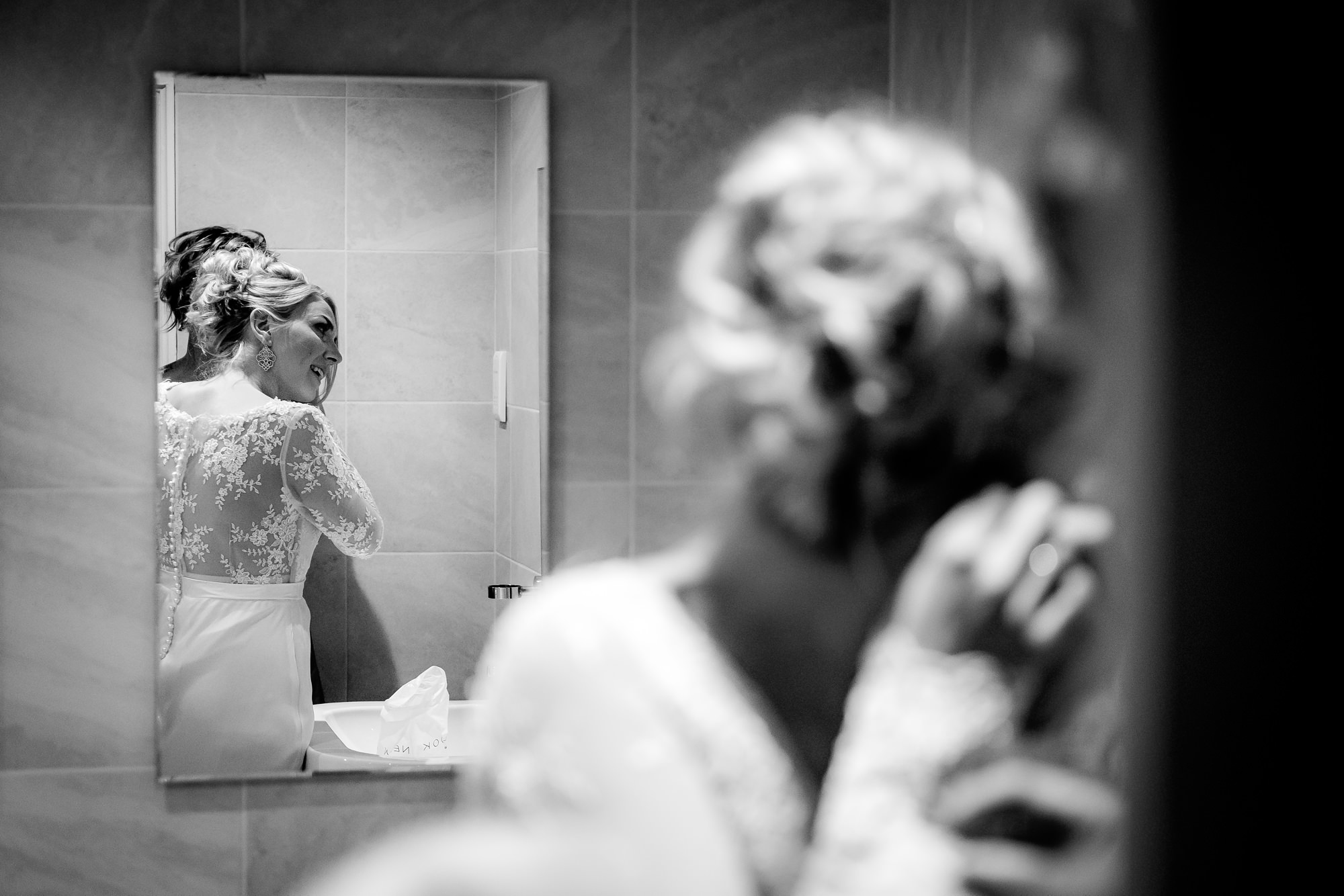 bride putting her earrings in