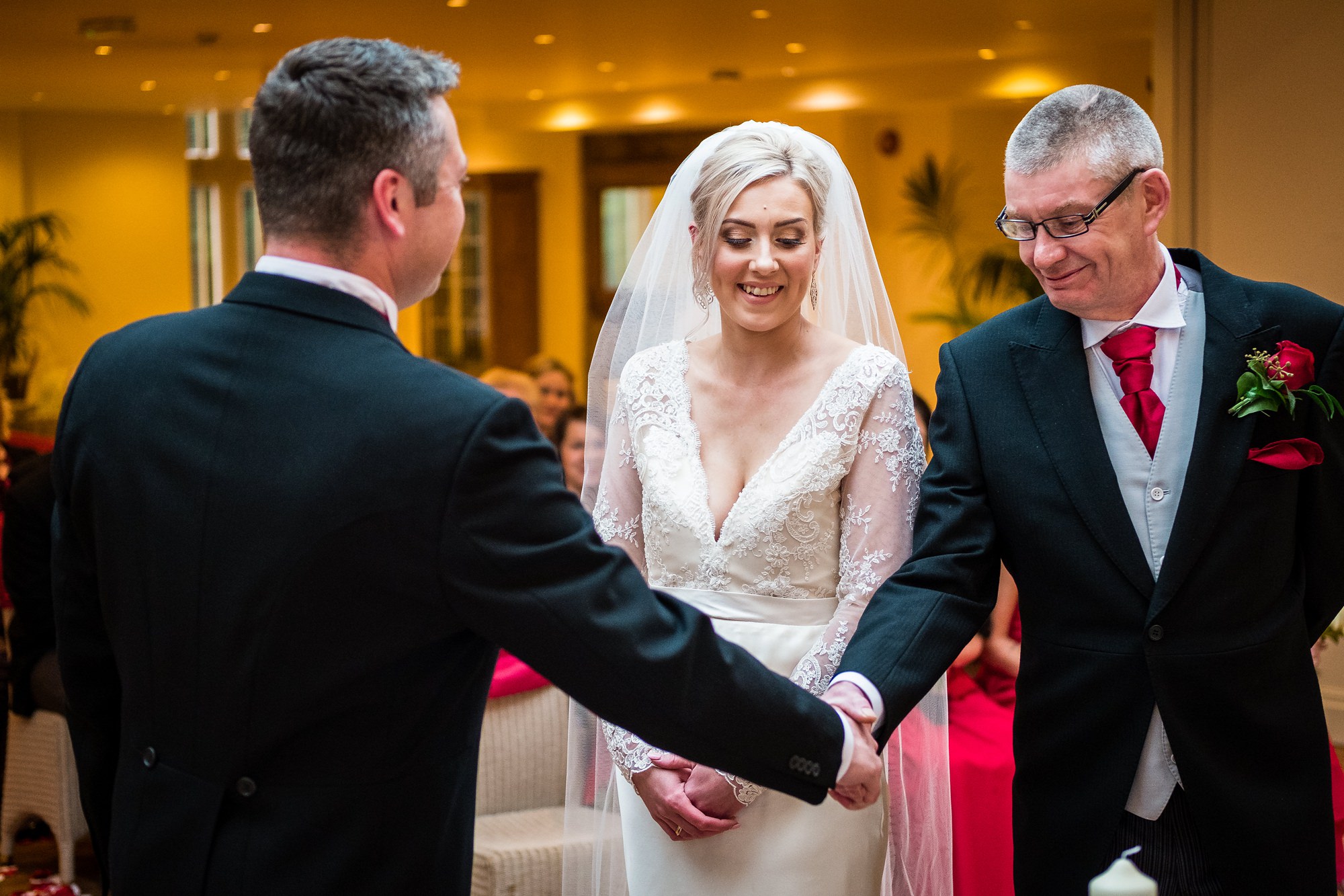 father of the bride handing bride over to groom