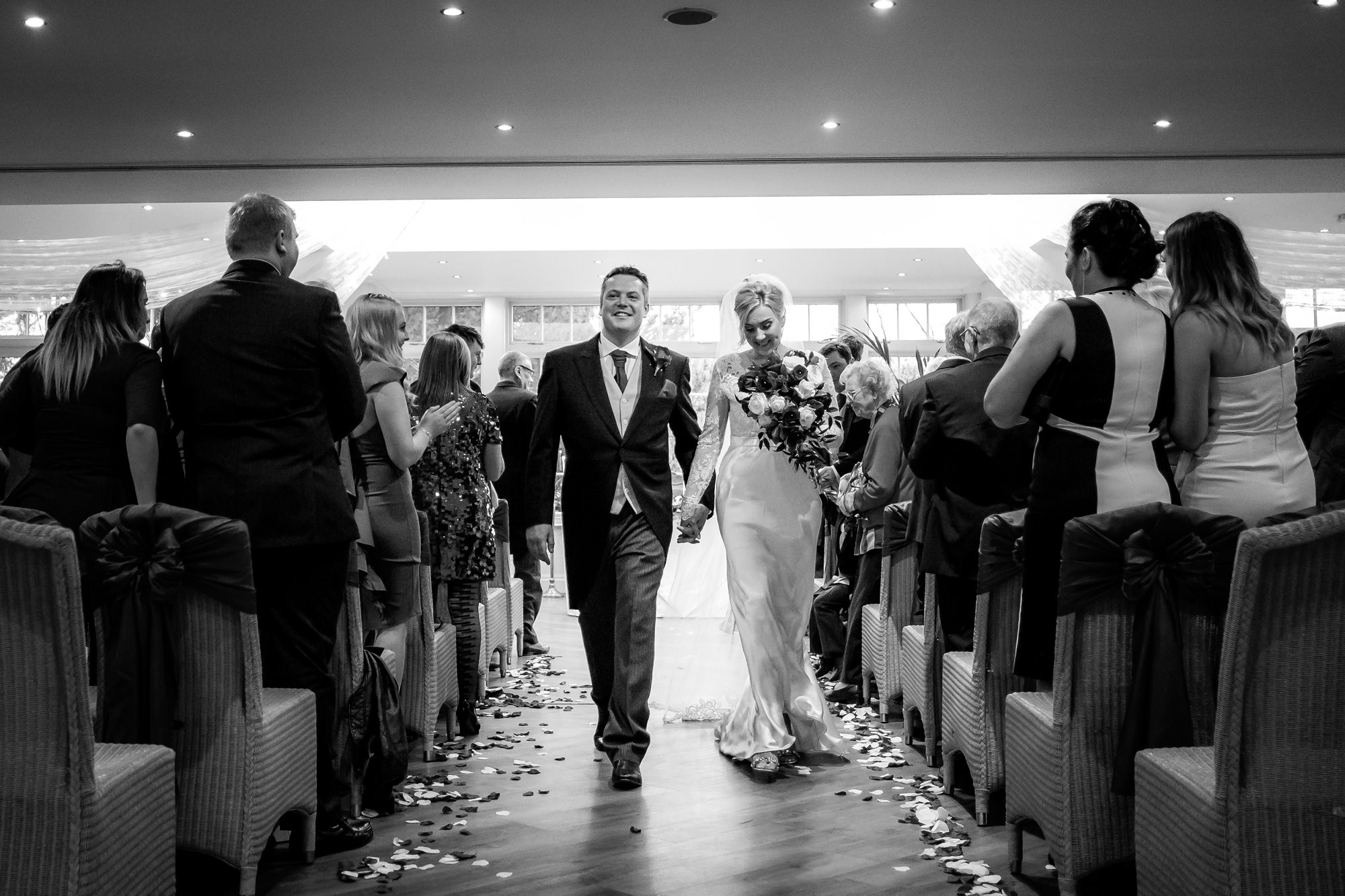 bride and groom walking down the aisle together