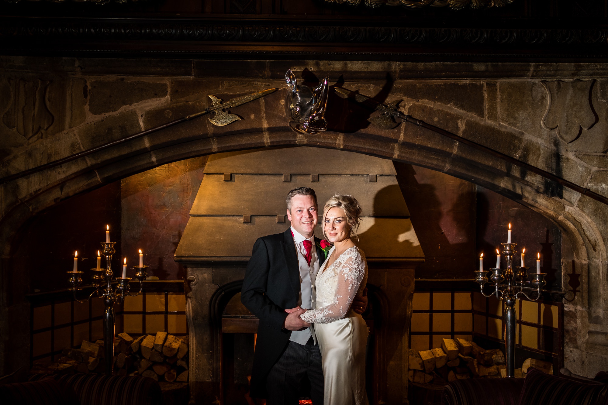 bride and groom in front of large fire