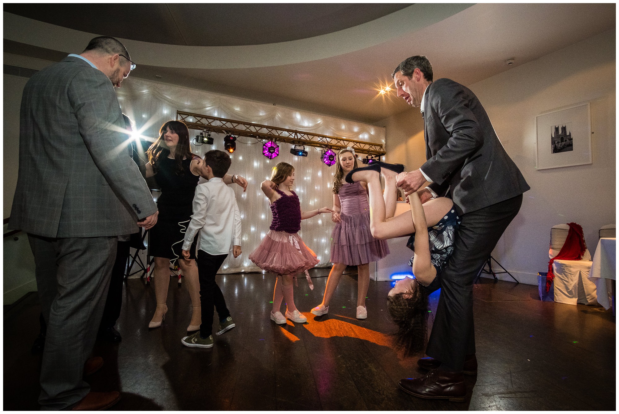 guest spinning child on dance floor