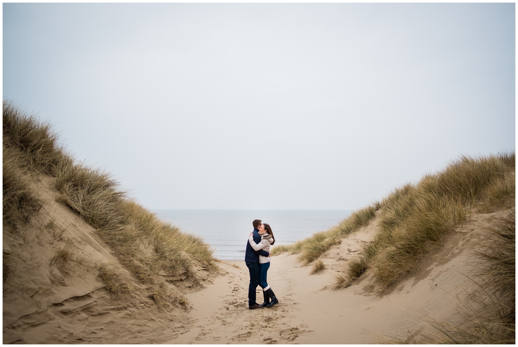 couple between sand dunes