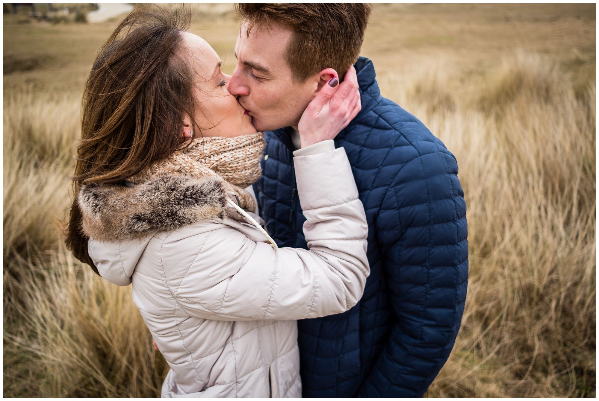 couple kissing in the grass