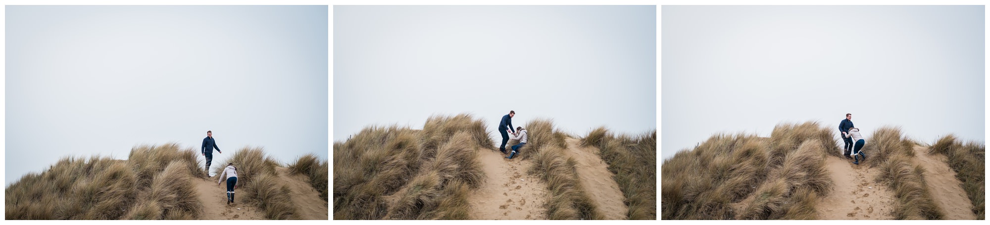 bride and groom to be climbing sand dunes
