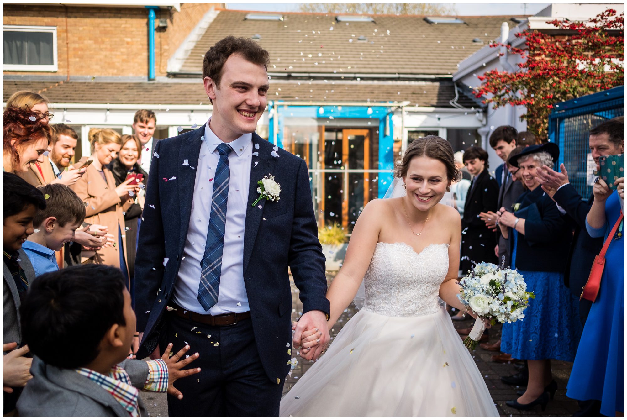 bride and groom walking through confetti