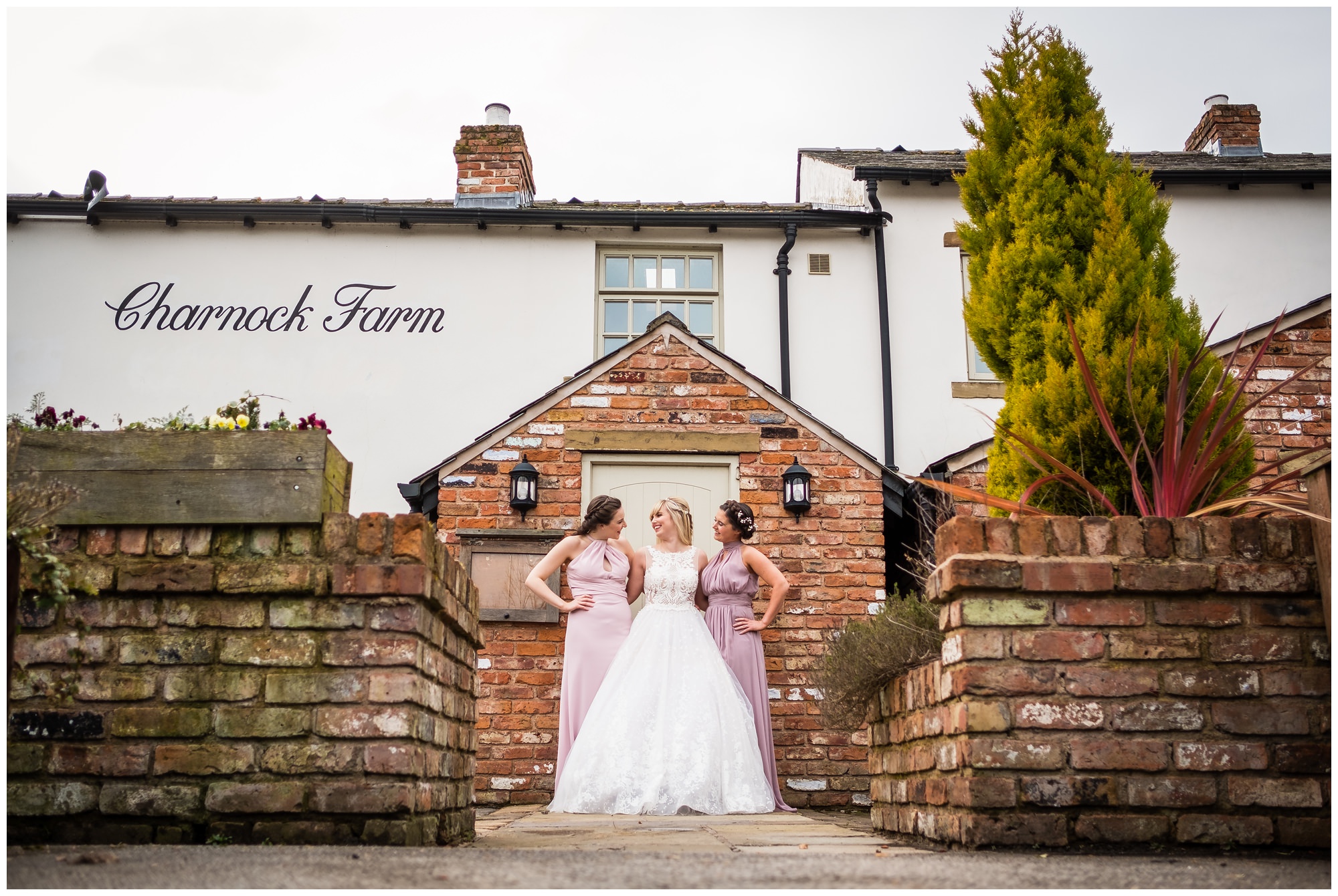 bridal party laughing outside charnock farm