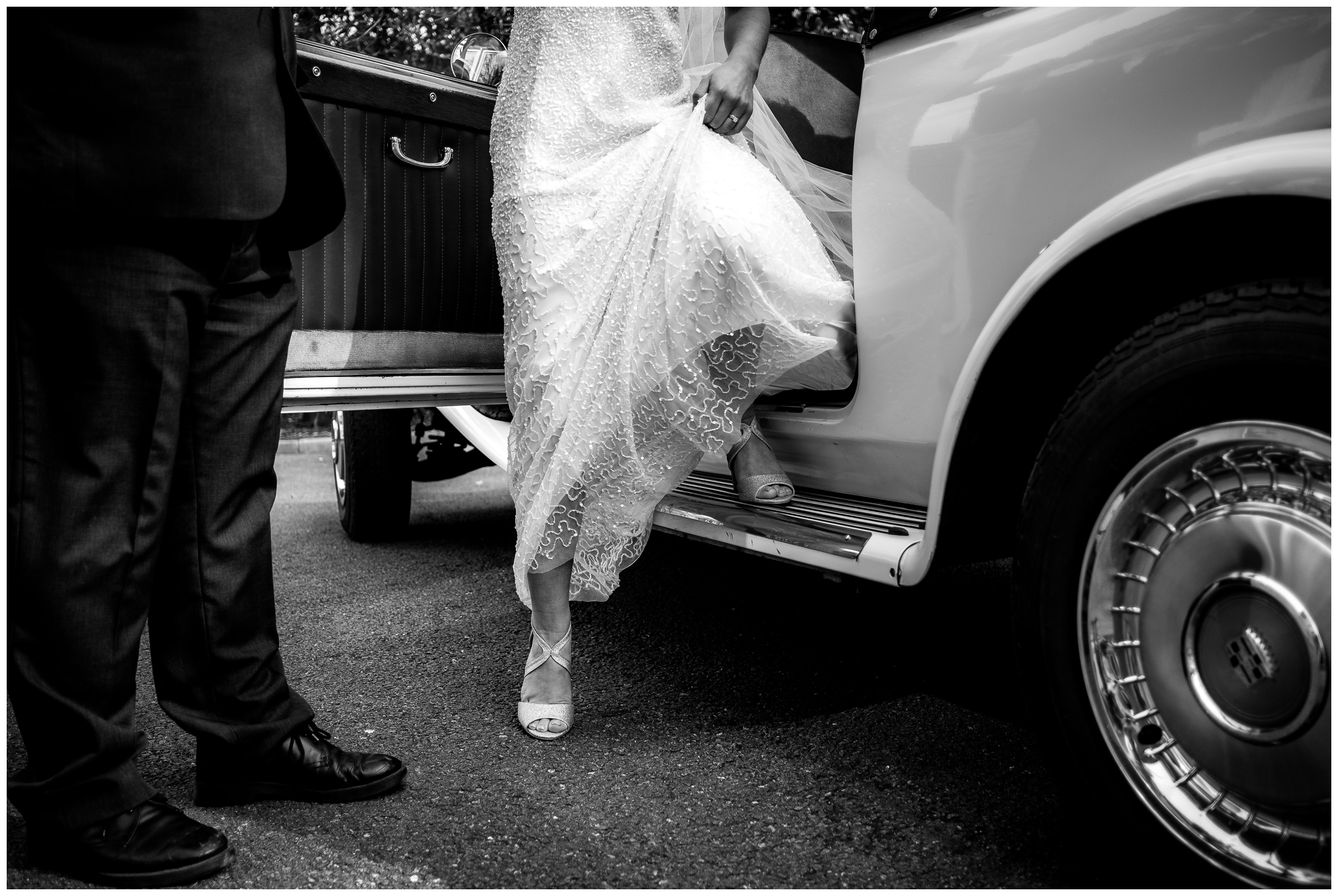 bride stepping out of wedding car at ashfield house, lancashire