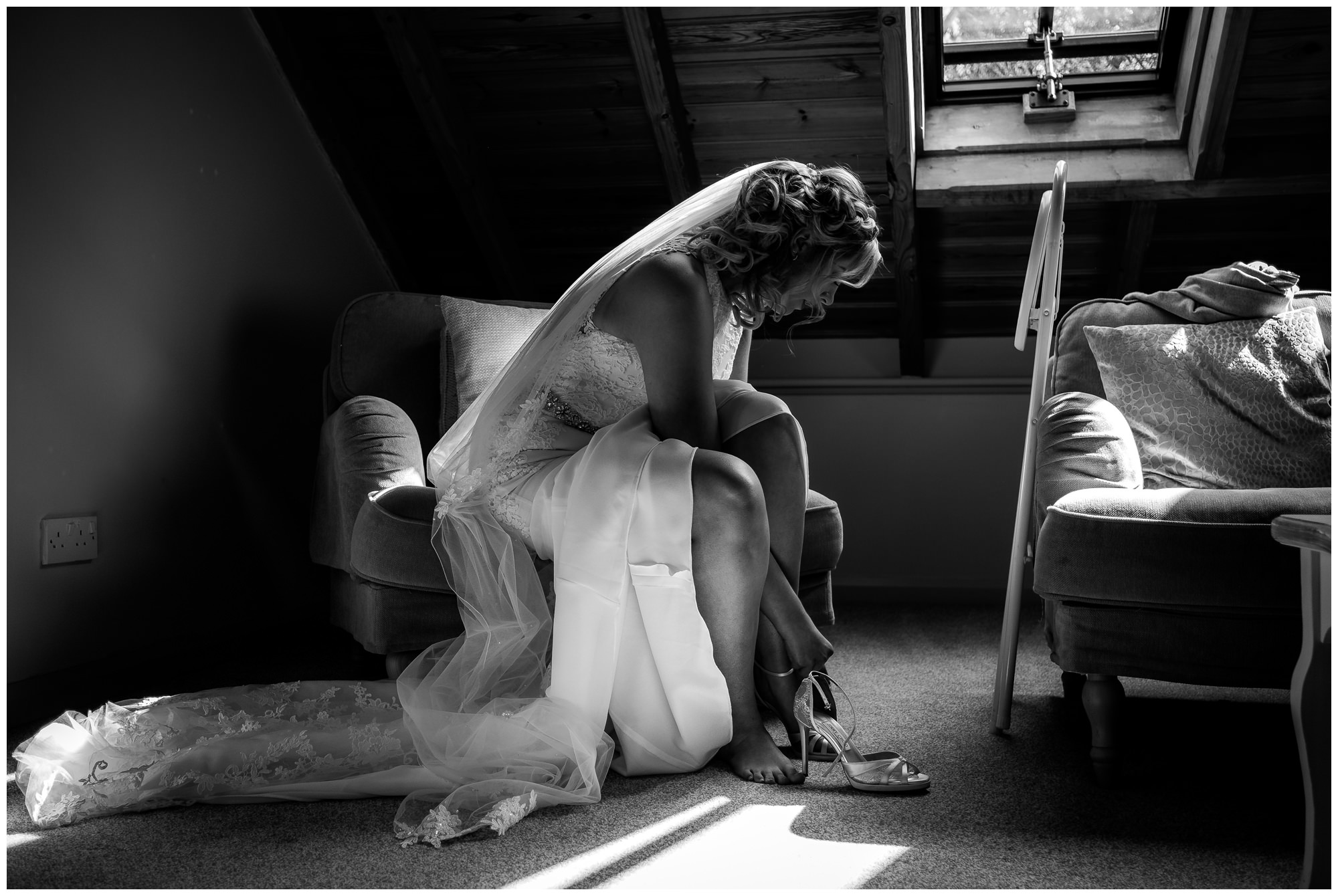 bride putting her wedding shoes on