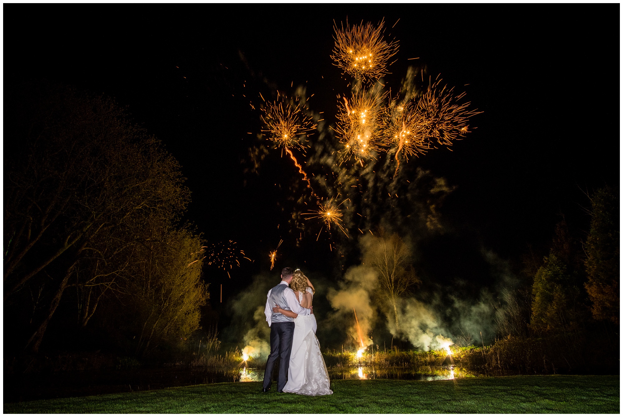 bride and groom during firework display