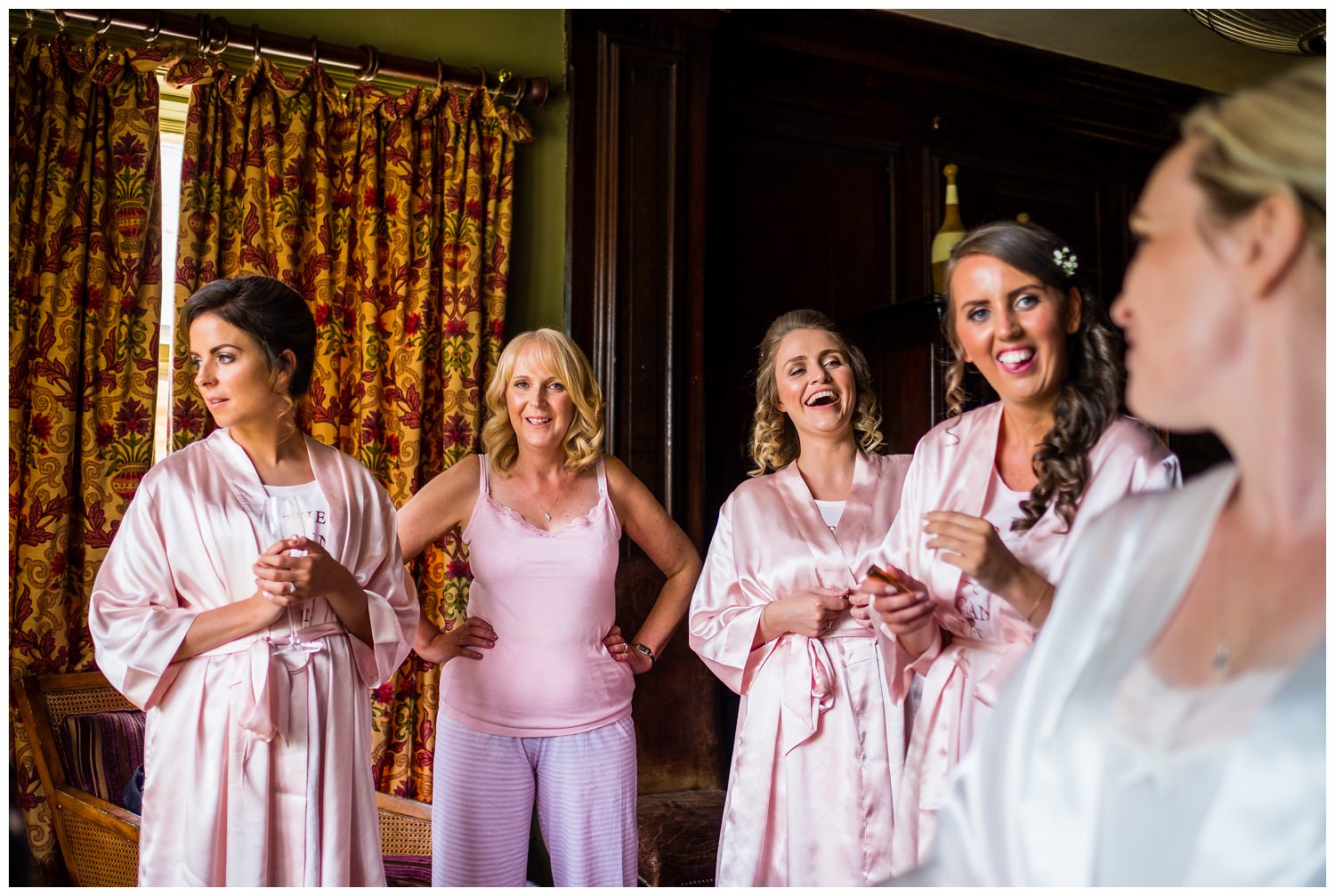bridesmaids smiling at the bride
