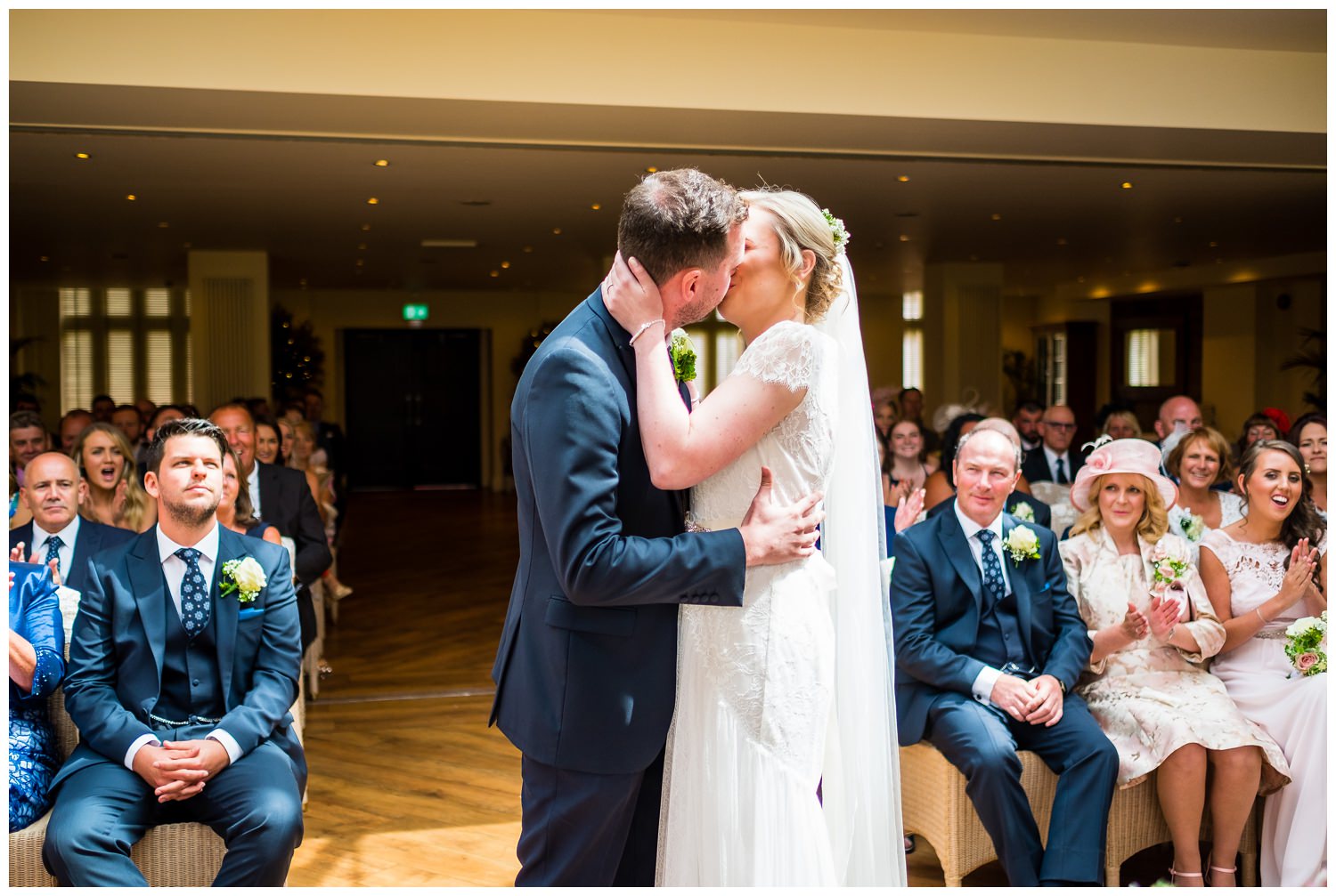 bride and groom first kiss