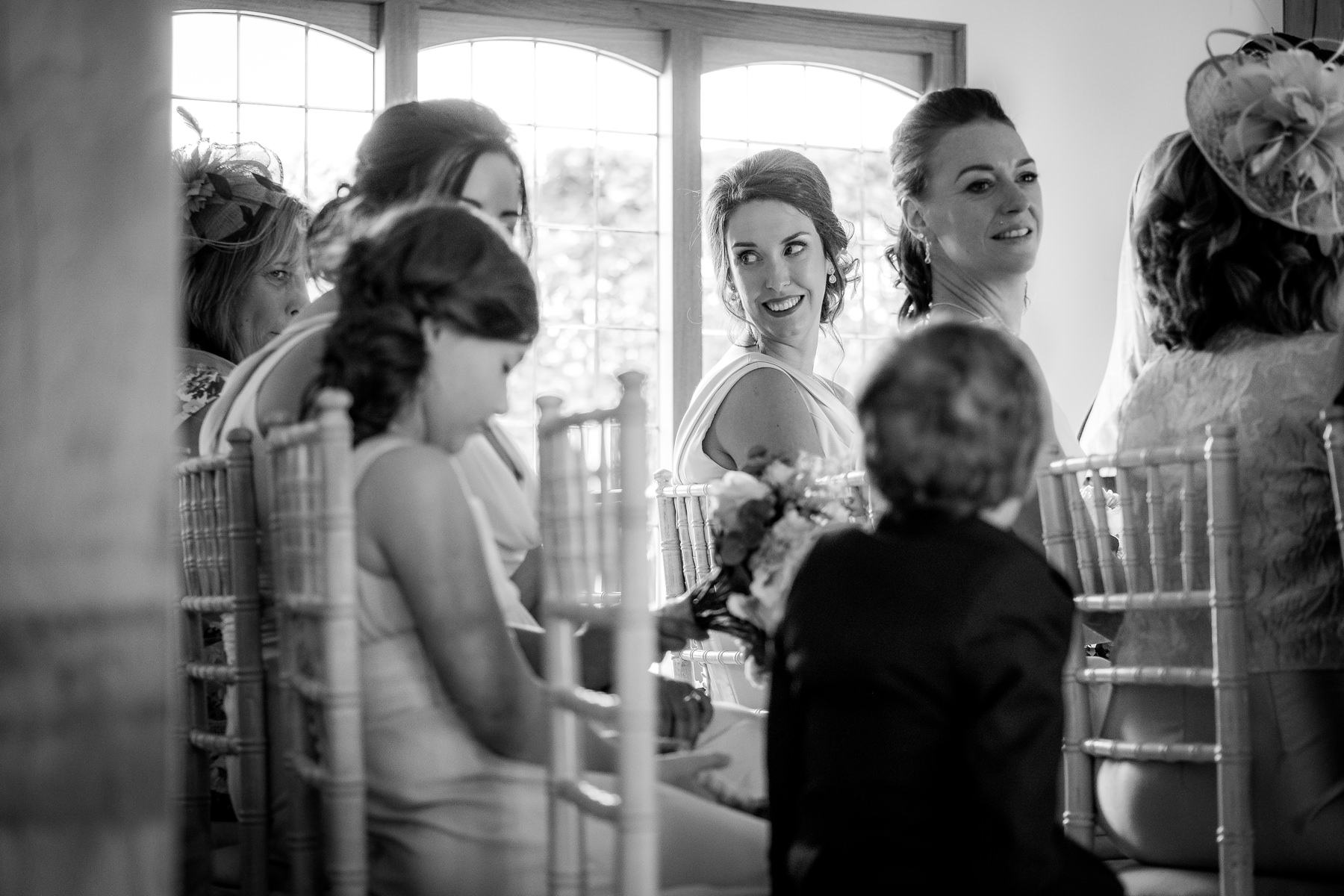 bridesmaid smiling during wedding ceremony