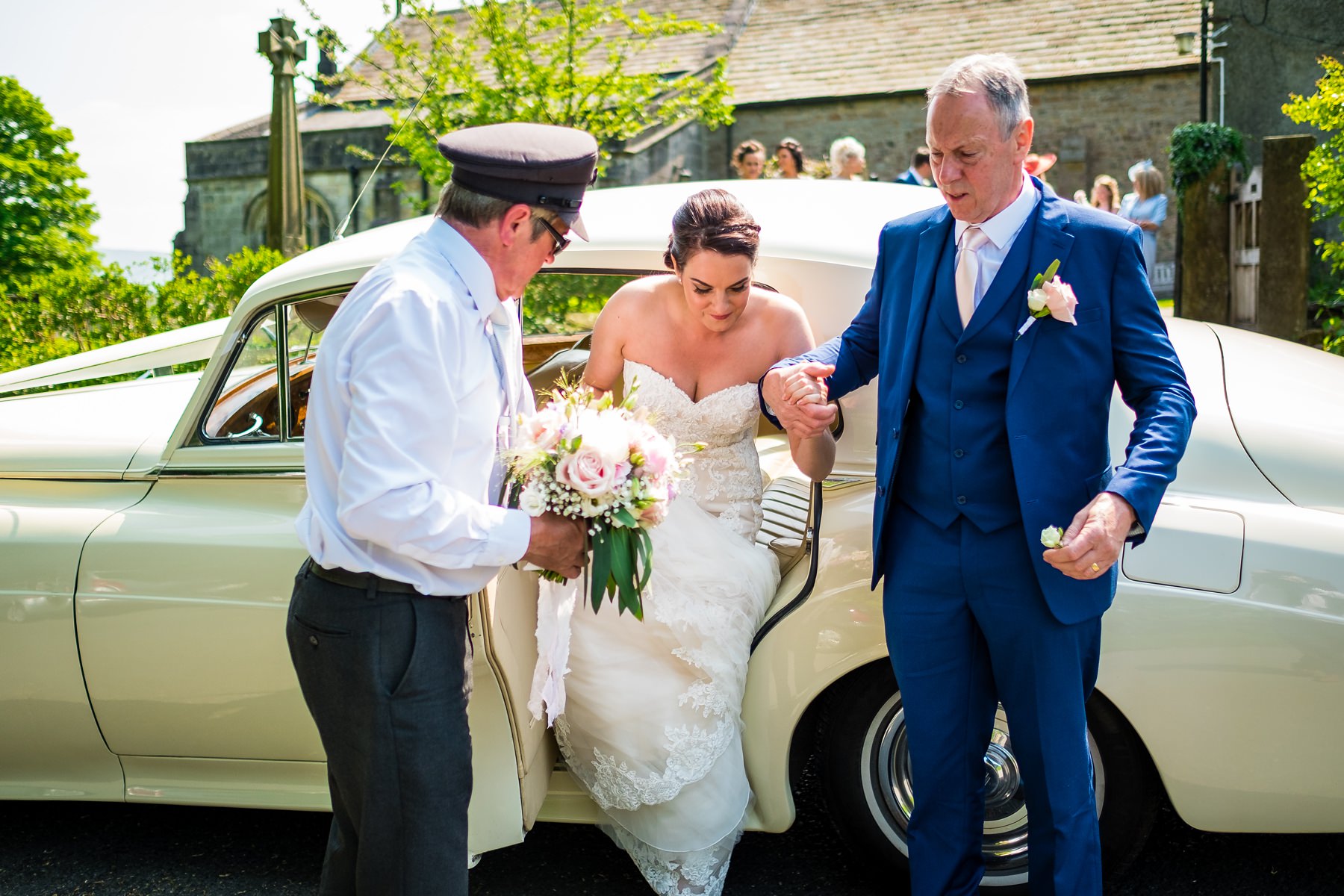 bride getting out of wedding car