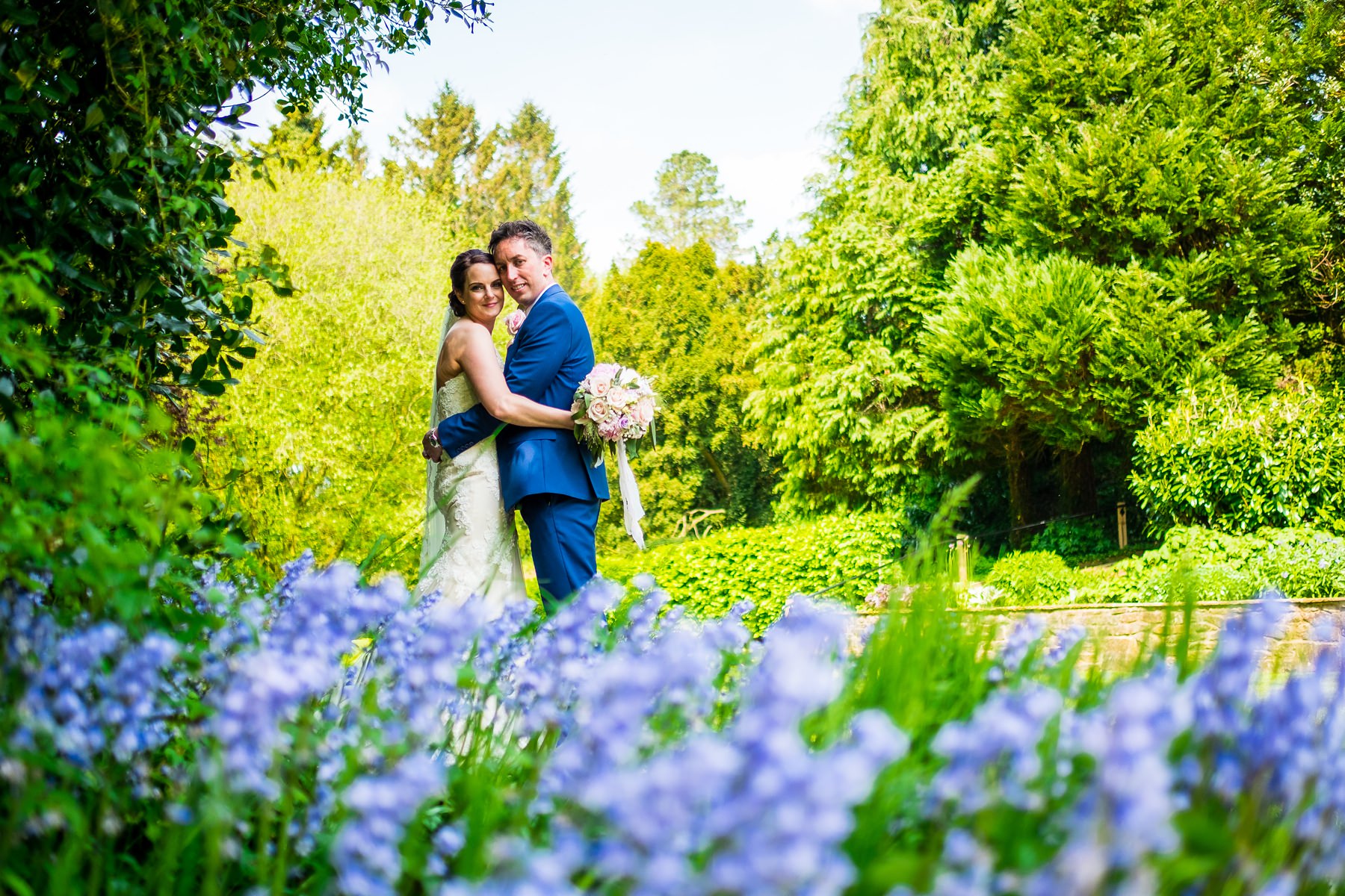 bride and groom with blue bells at mitton hall