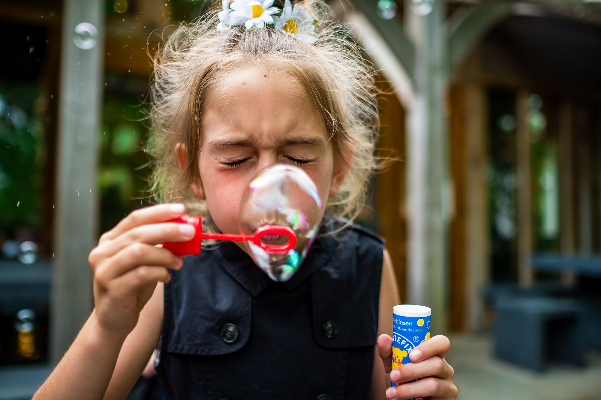 child blowing bubbles