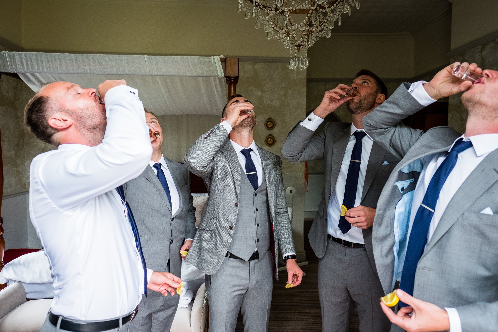 groom and groomsmen doing shots