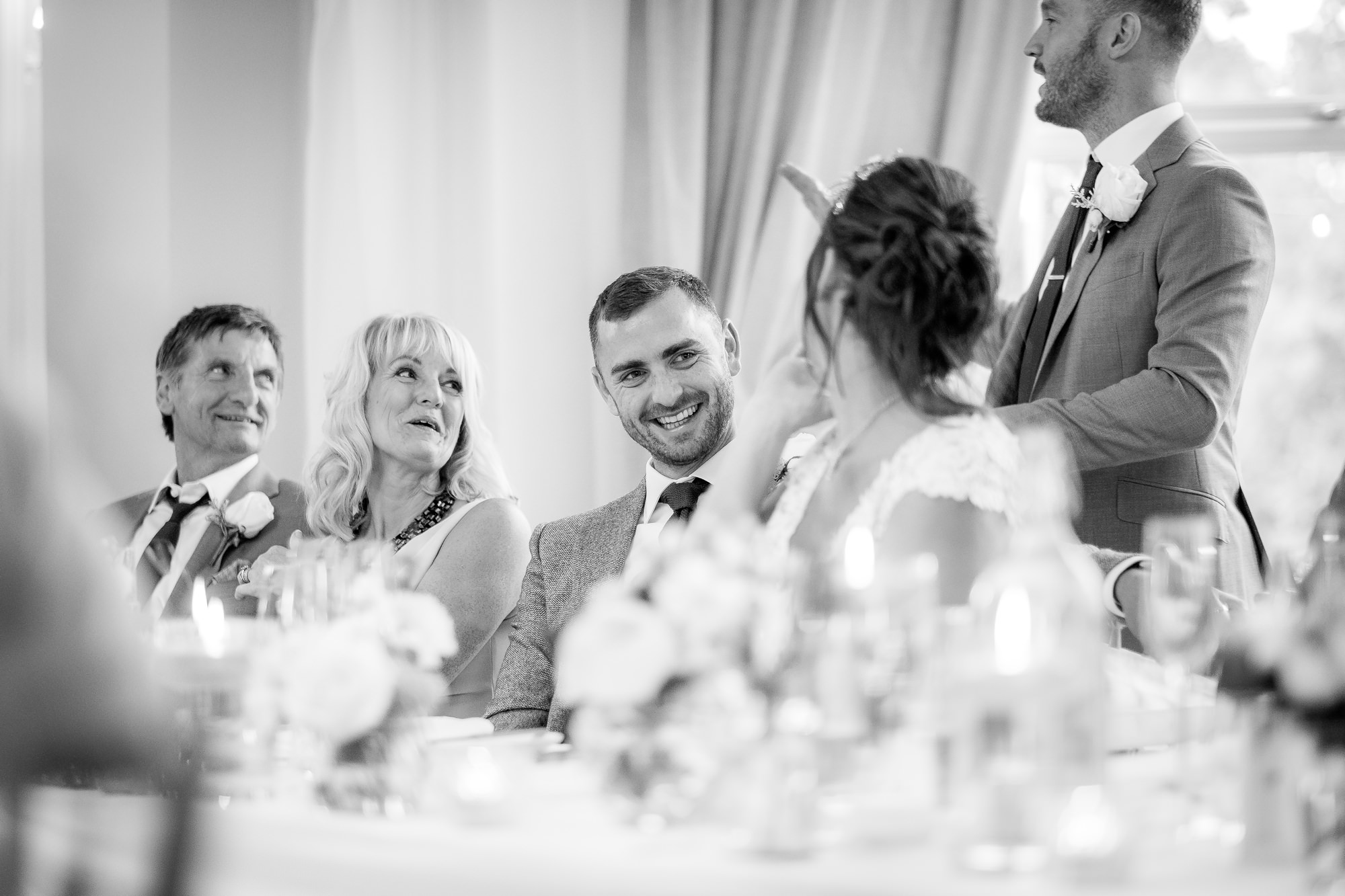 groom laughing during best man speech