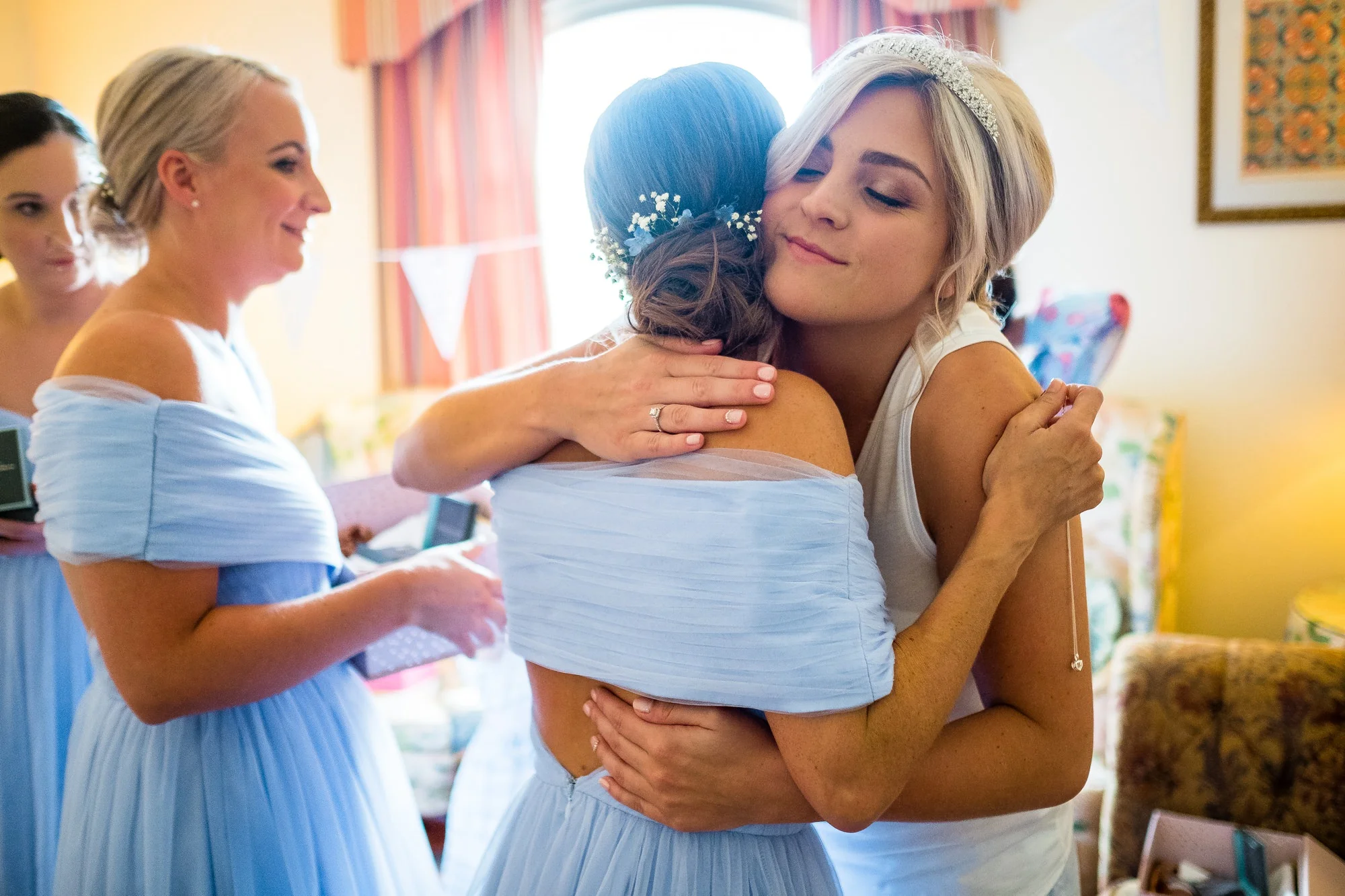 bride hugging bridesmaid