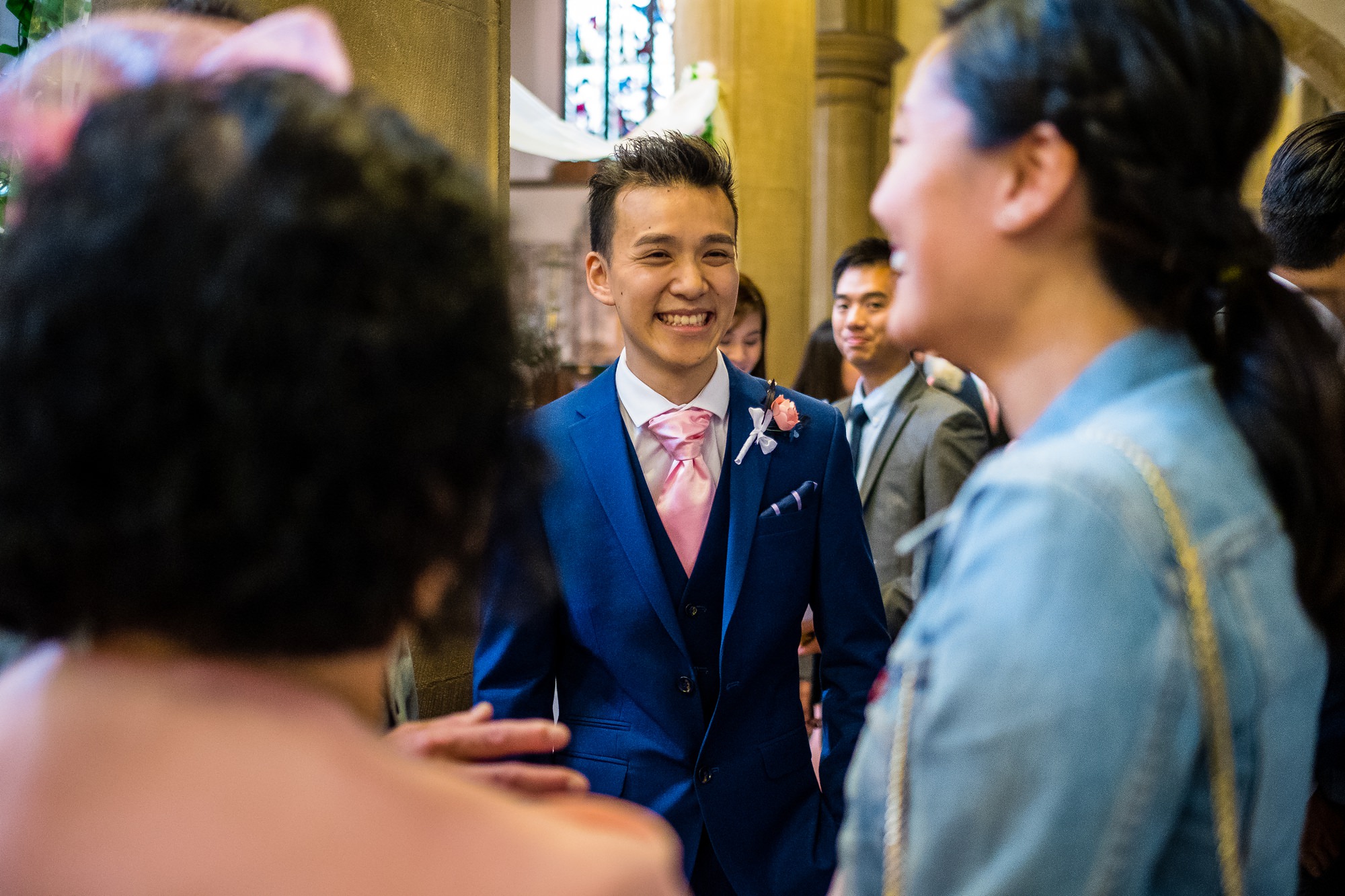 groom greeting guests at church