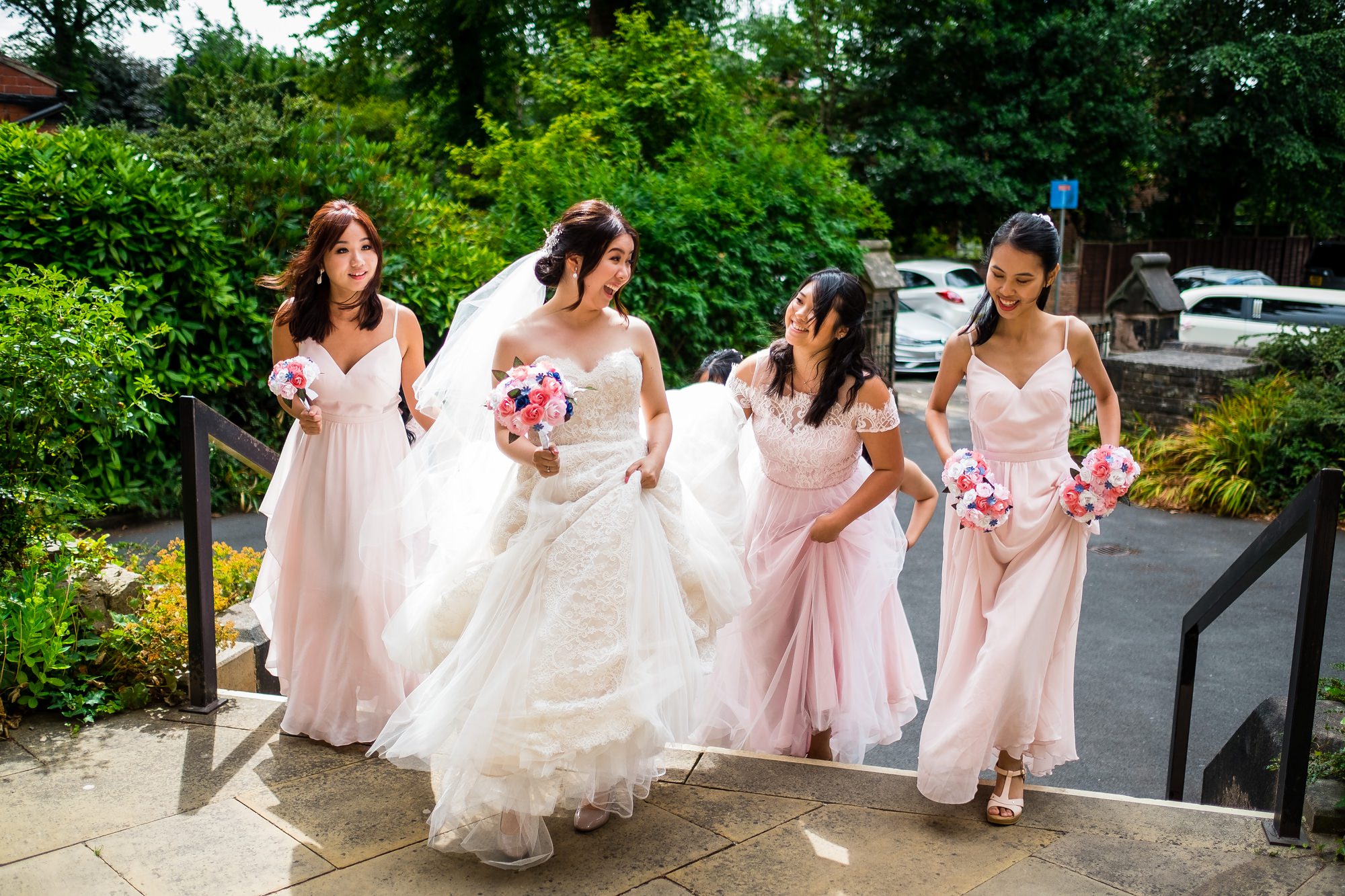 bride arriving at church with bridesmaids