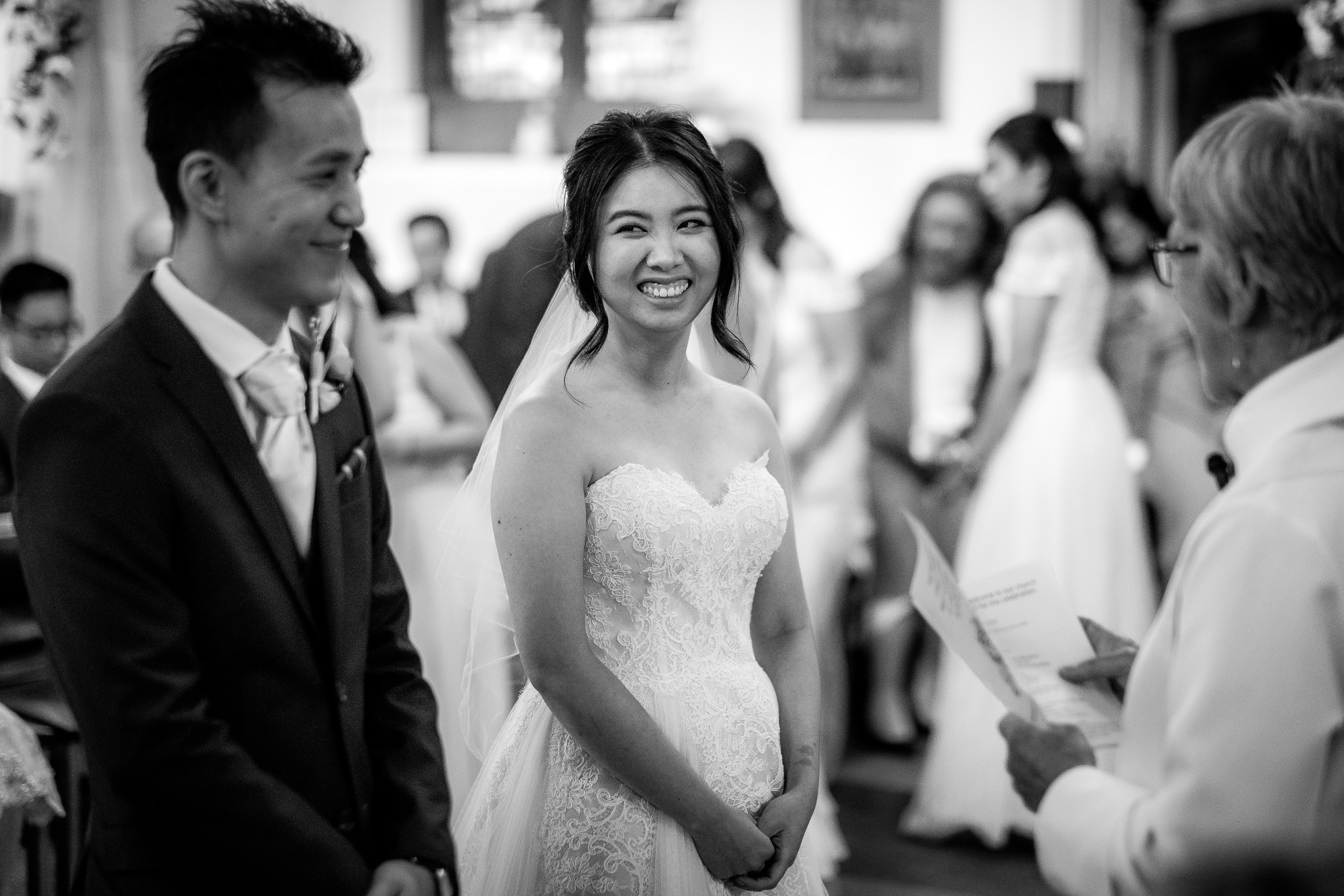 bride smiling to groom in Manchester church