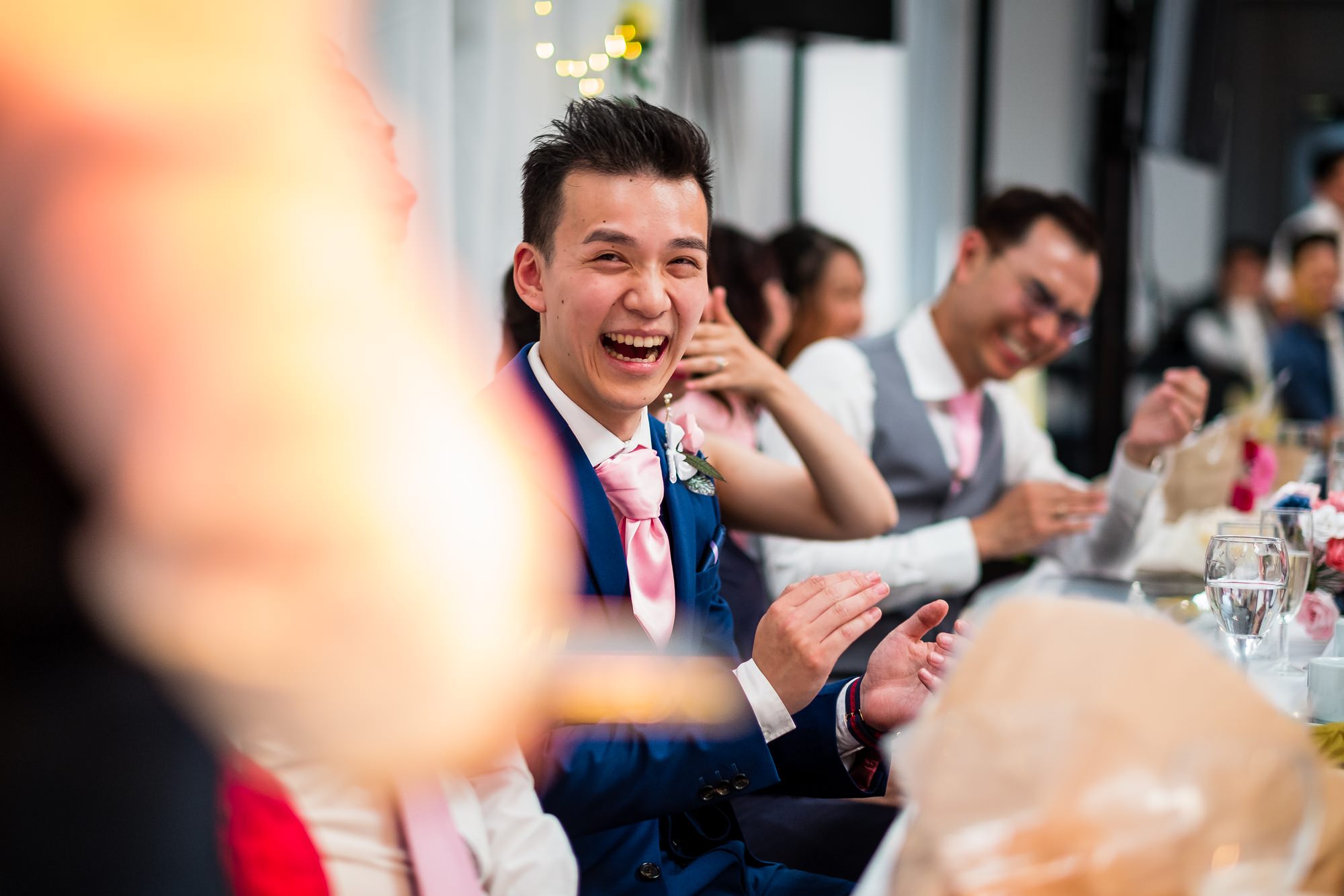 groom laughing during speeches
