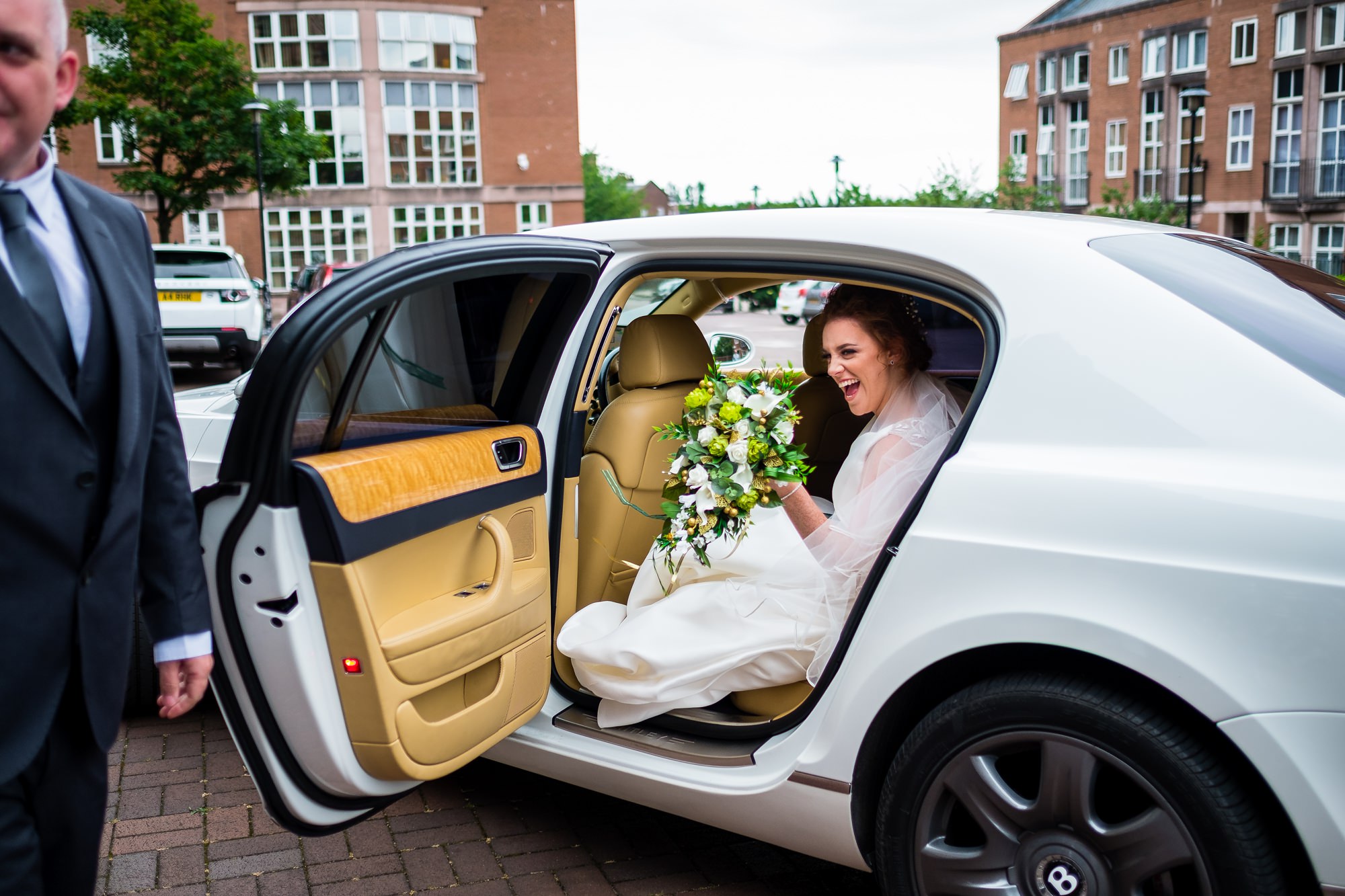 bride getting out of wedding car