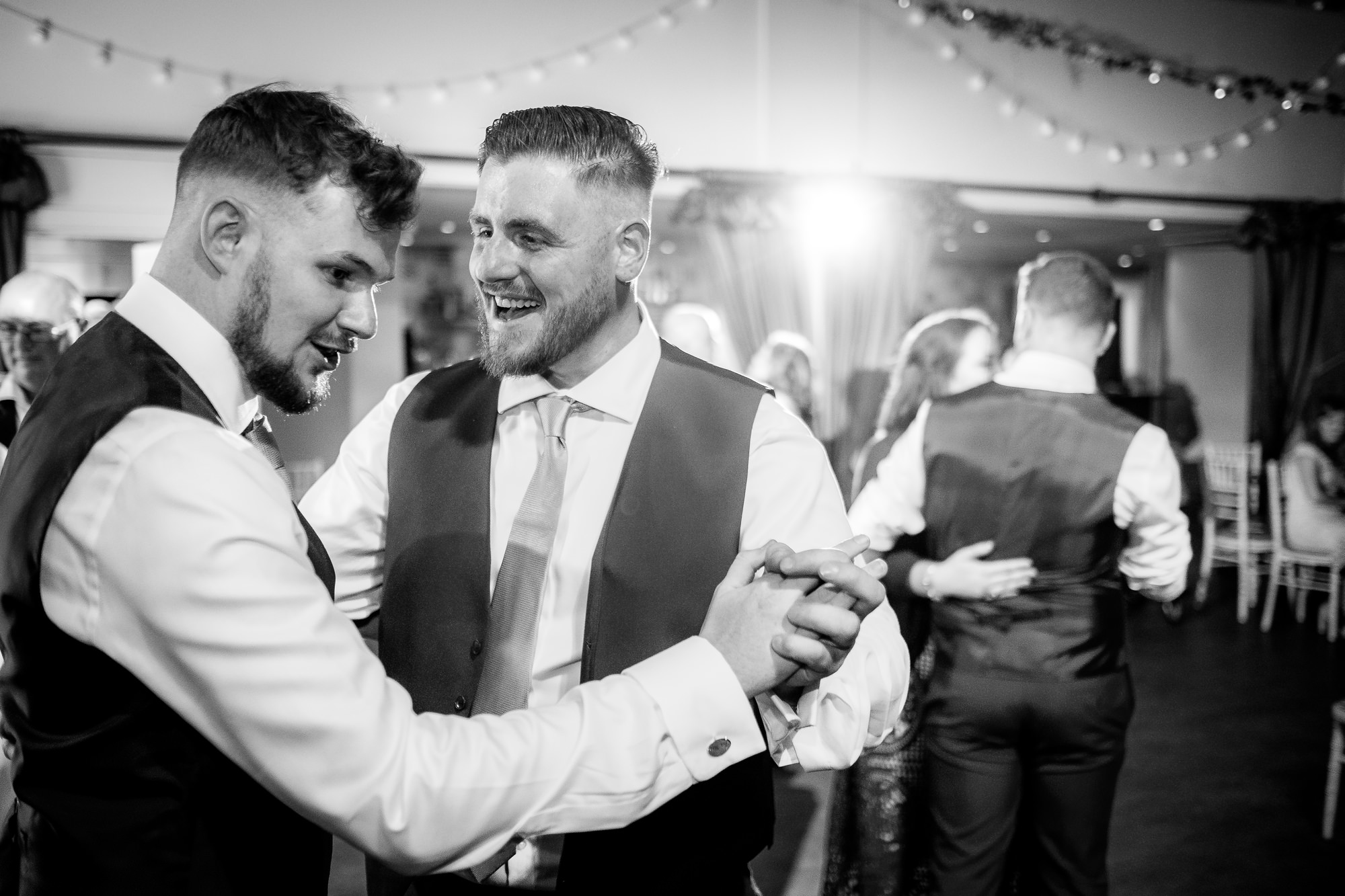 best men dancing together