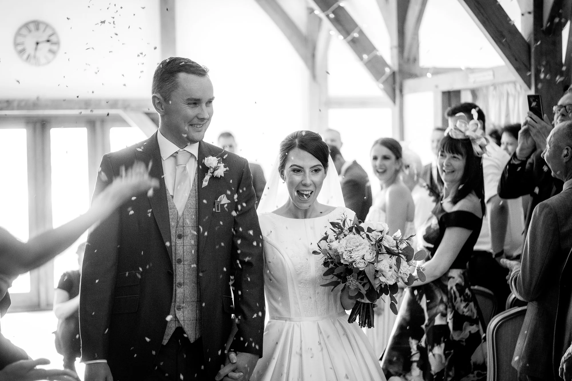 bride and groom walking through confetti