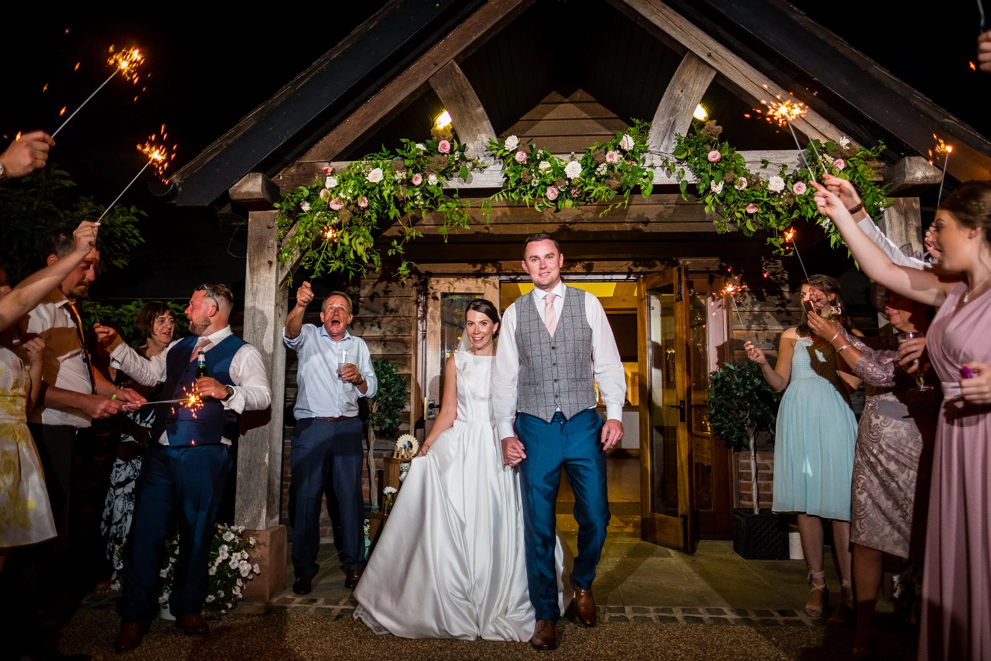 bride and groom walking through sparklers