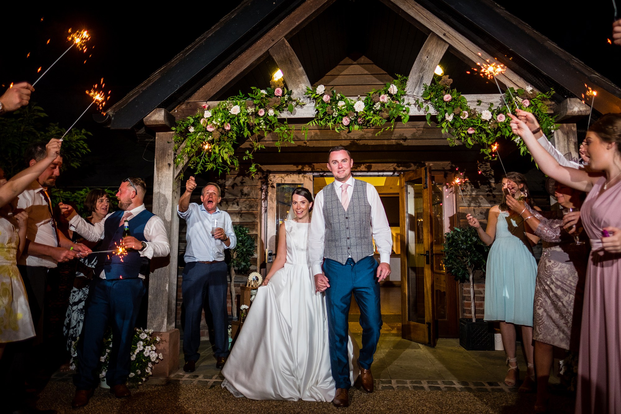 bride and groom walking through sparklers