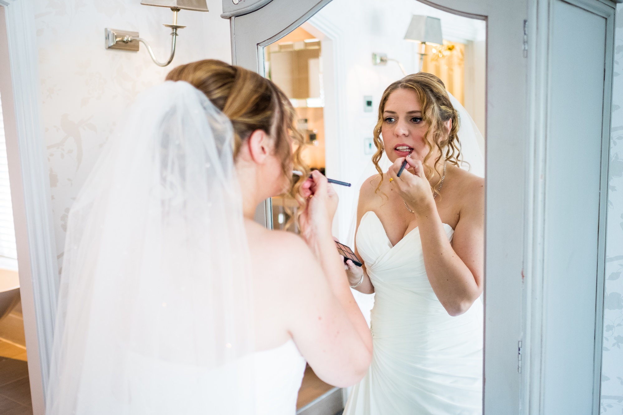 bride putting on makeup