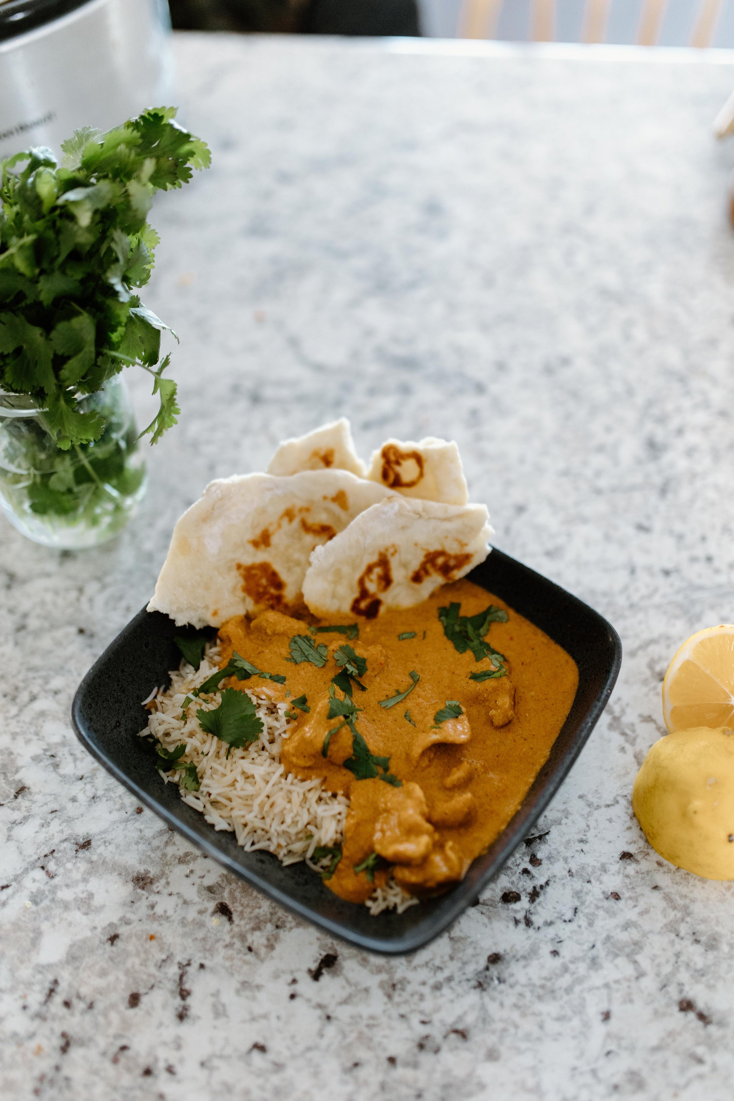 Cilantro garnished slow cooker butter chicken with rice