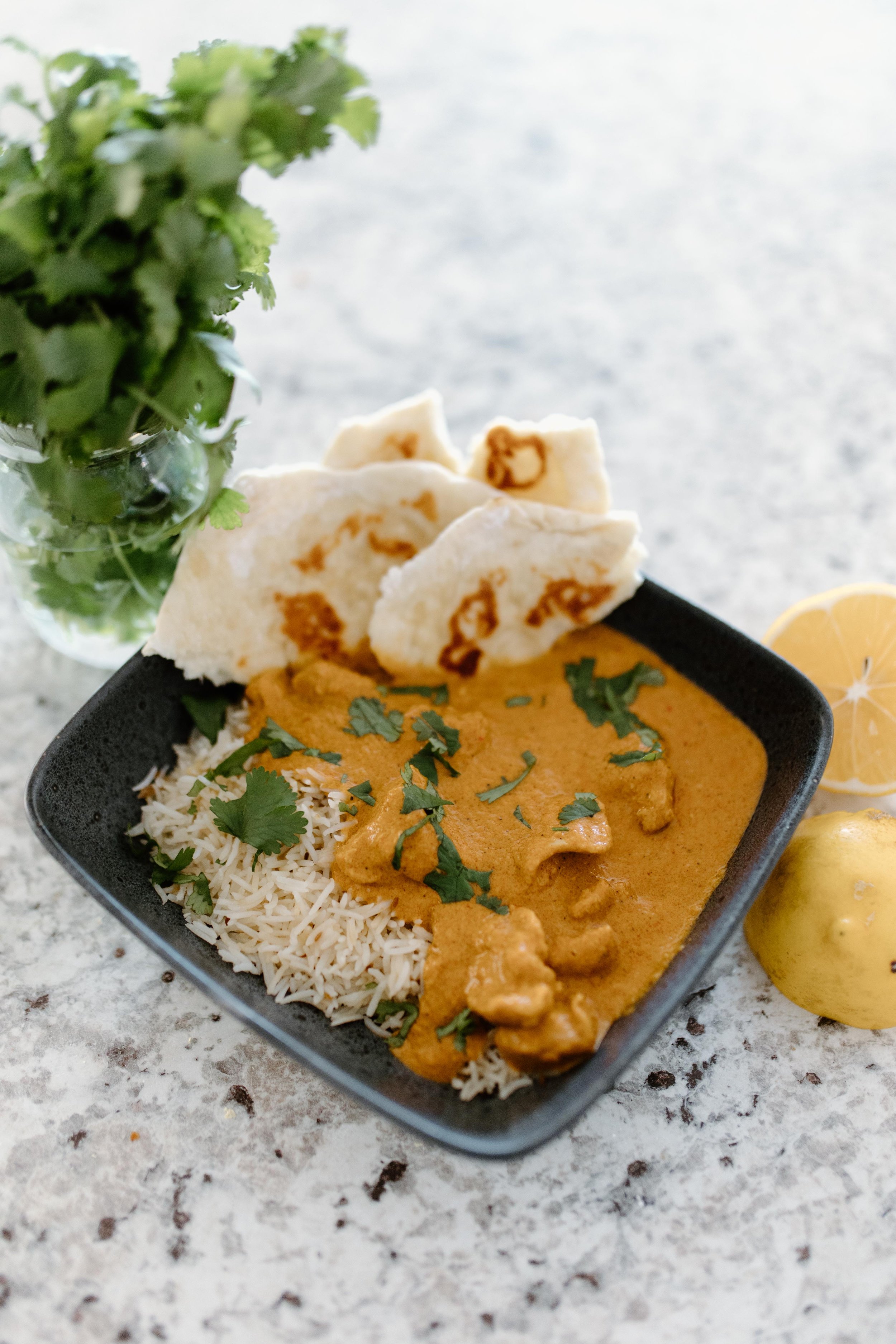 Quick and easy slow cooker butter chicken with rice and garlic naan