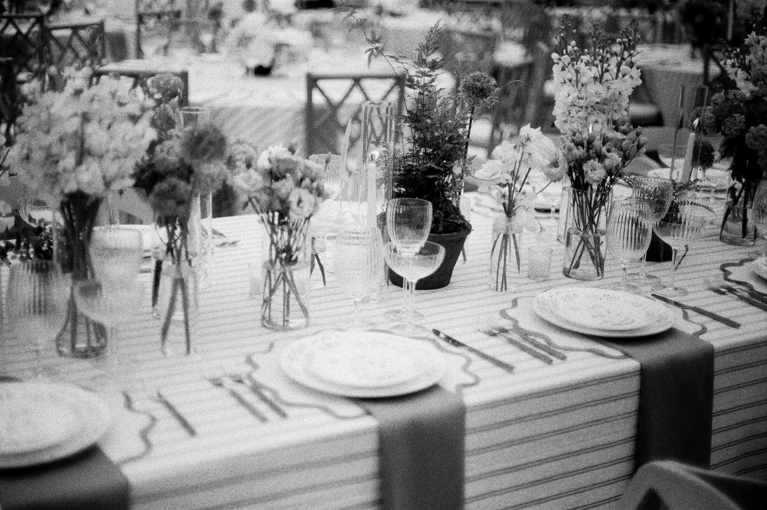 black and white film photo of a reception table setting.