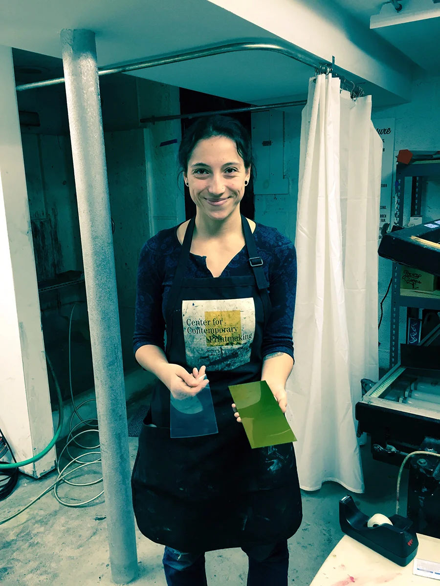 Christina Pumo offered to help me with photo polymer plates. Here she's showing me how to make test plates.