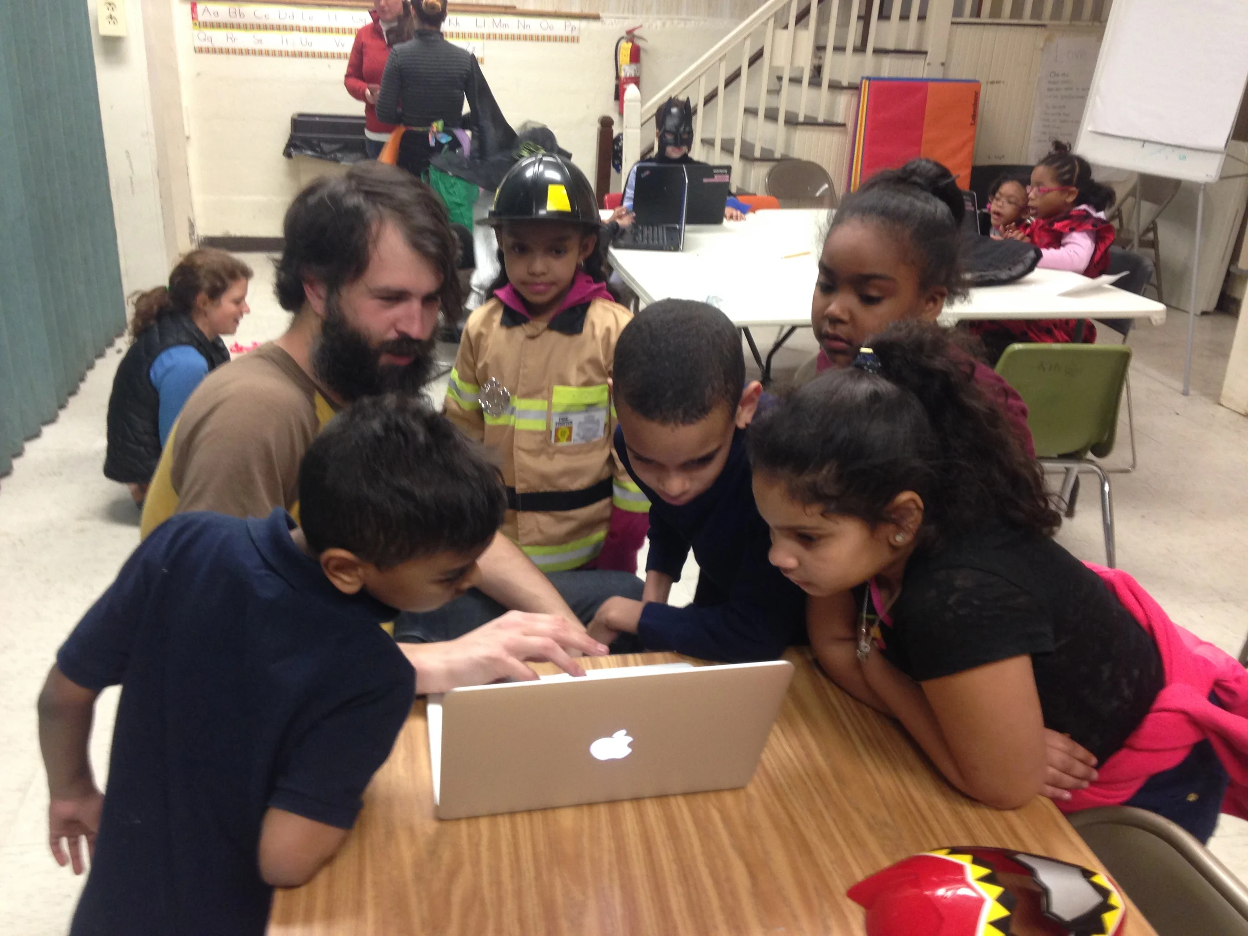 Zac Delagrange, Software Engineer at BitSight Technologies, shows children code at career day.