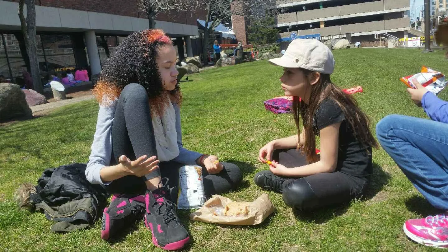 Students enjoy lunch in the sun.