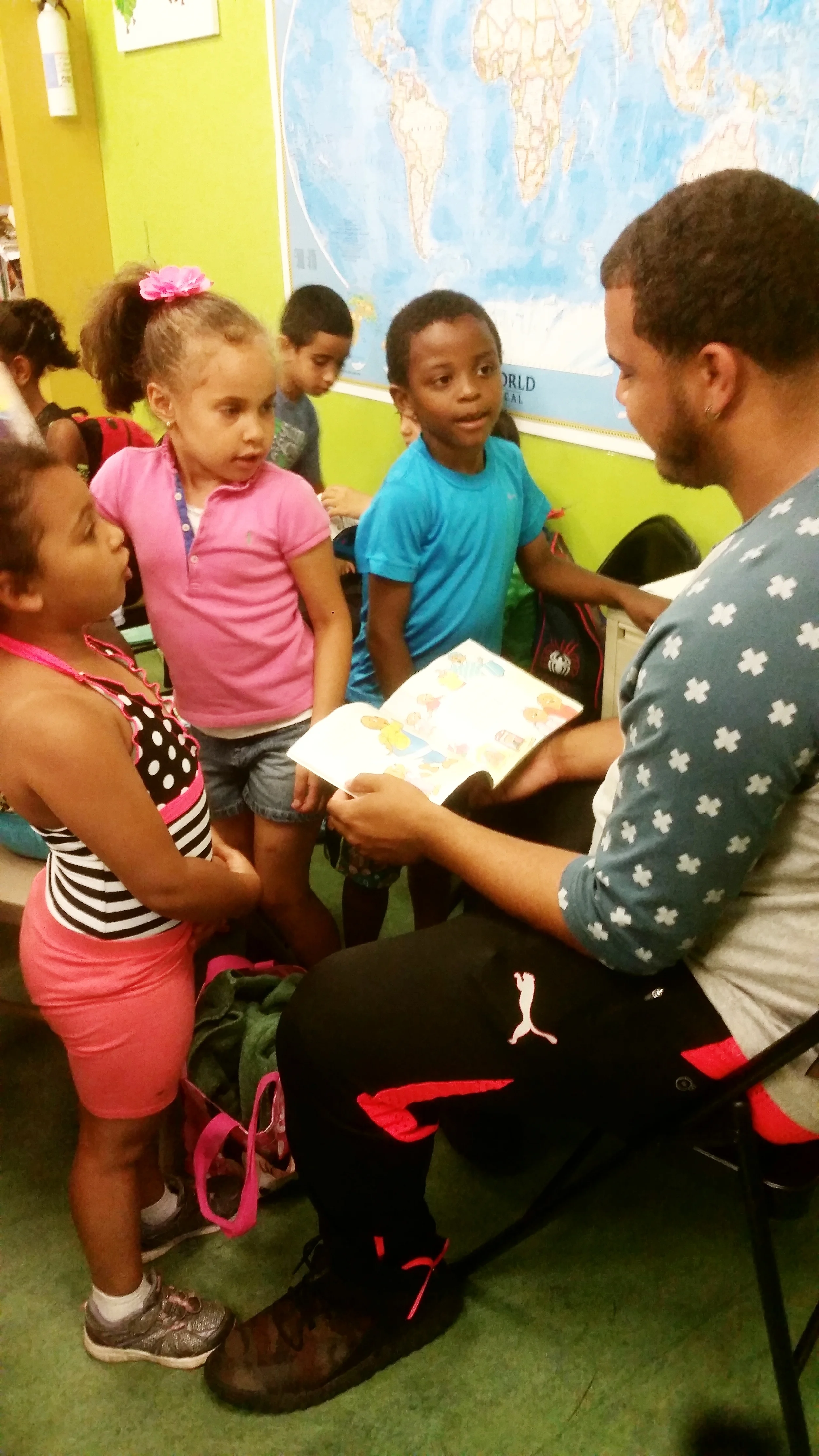 Didier stops by to say hi and volunteers to read with youngest group during DEAR time. 