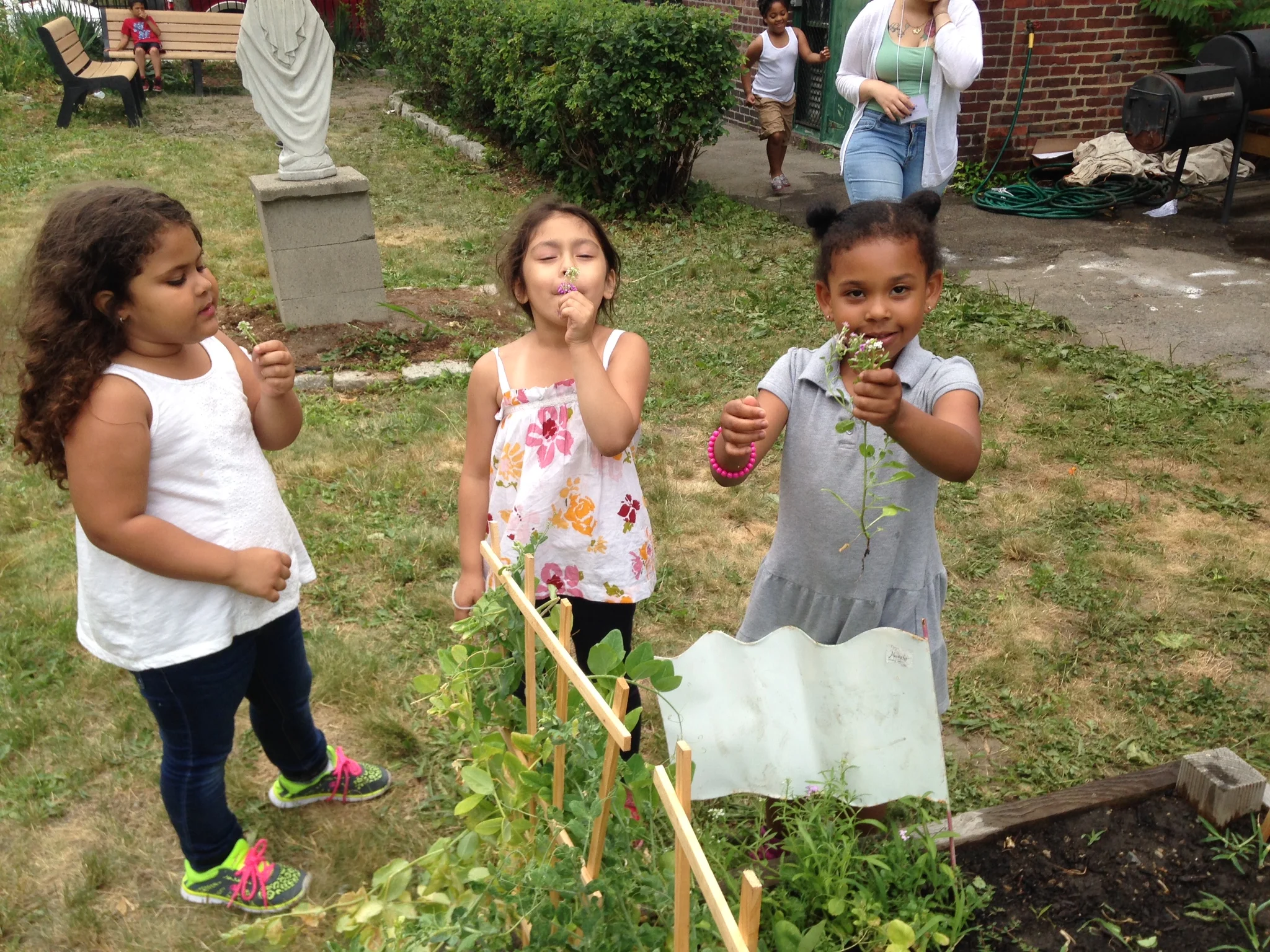 Kids picking peas and smelling wildflowers